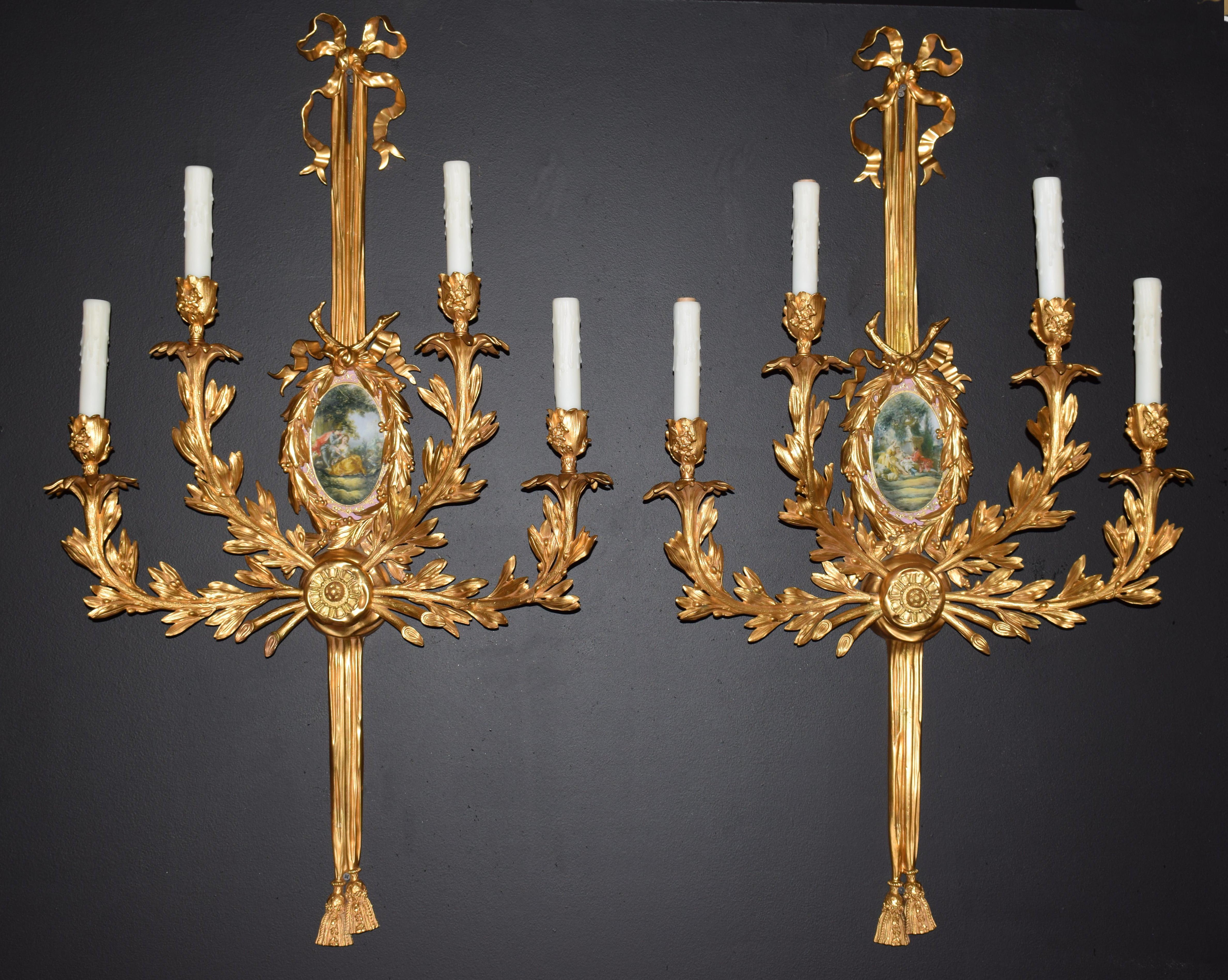 A pair of Louis XVI style gilt-bronze four-light wall sconces, incorporating a reserve fitted with a decorated oval porcelain plaque.
Four-light
Measures: Height 41.5 inches x width 24 inches x depth 6 1/2 inches.
CW4838.