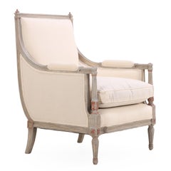 A pair of Louis XVI style grey painted and partial gilt Bergere chairs, C. 1940.