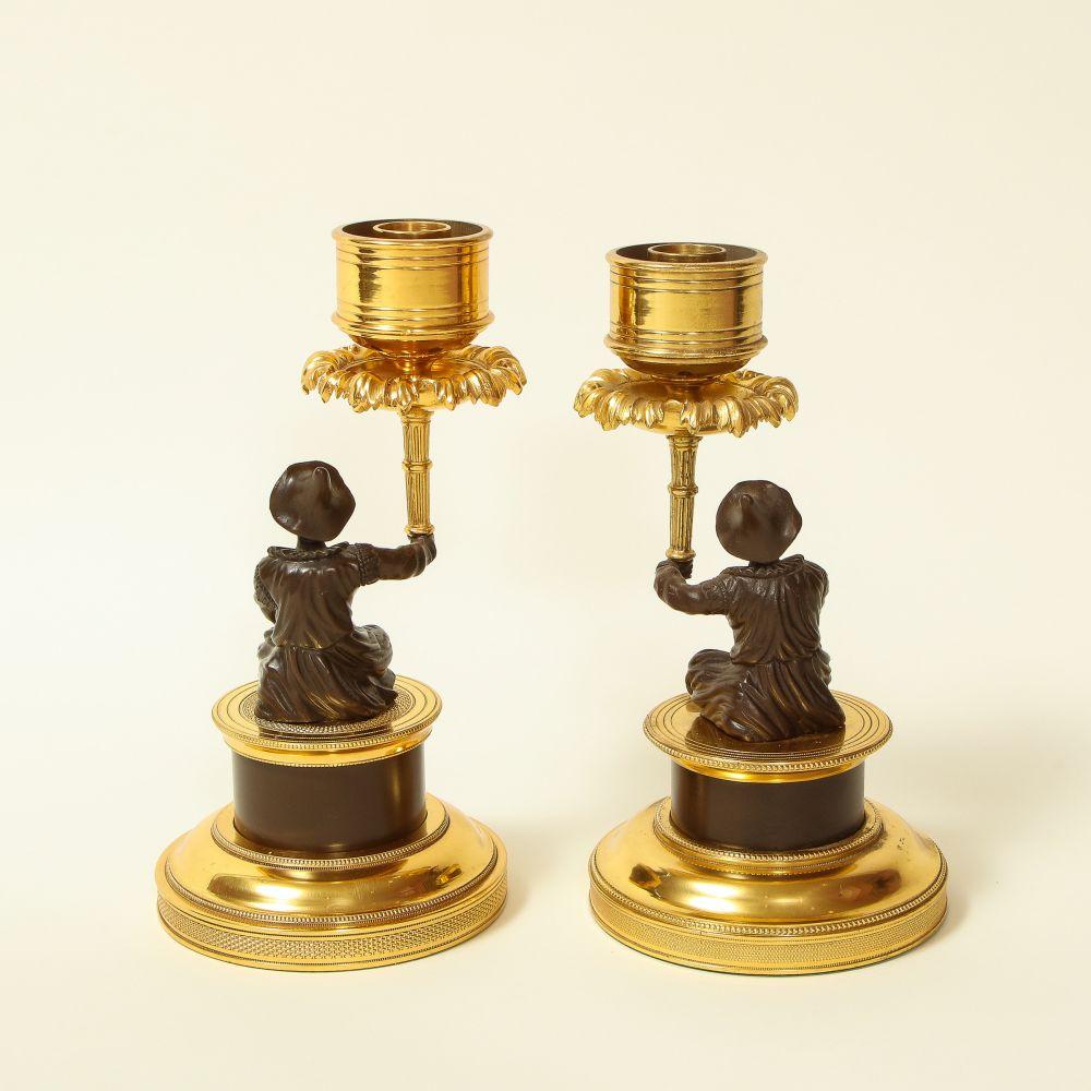 French Pair of Louis XVI Style Harlequin Figural Bronze and Gilt-Bronze Candlesticks For Sale