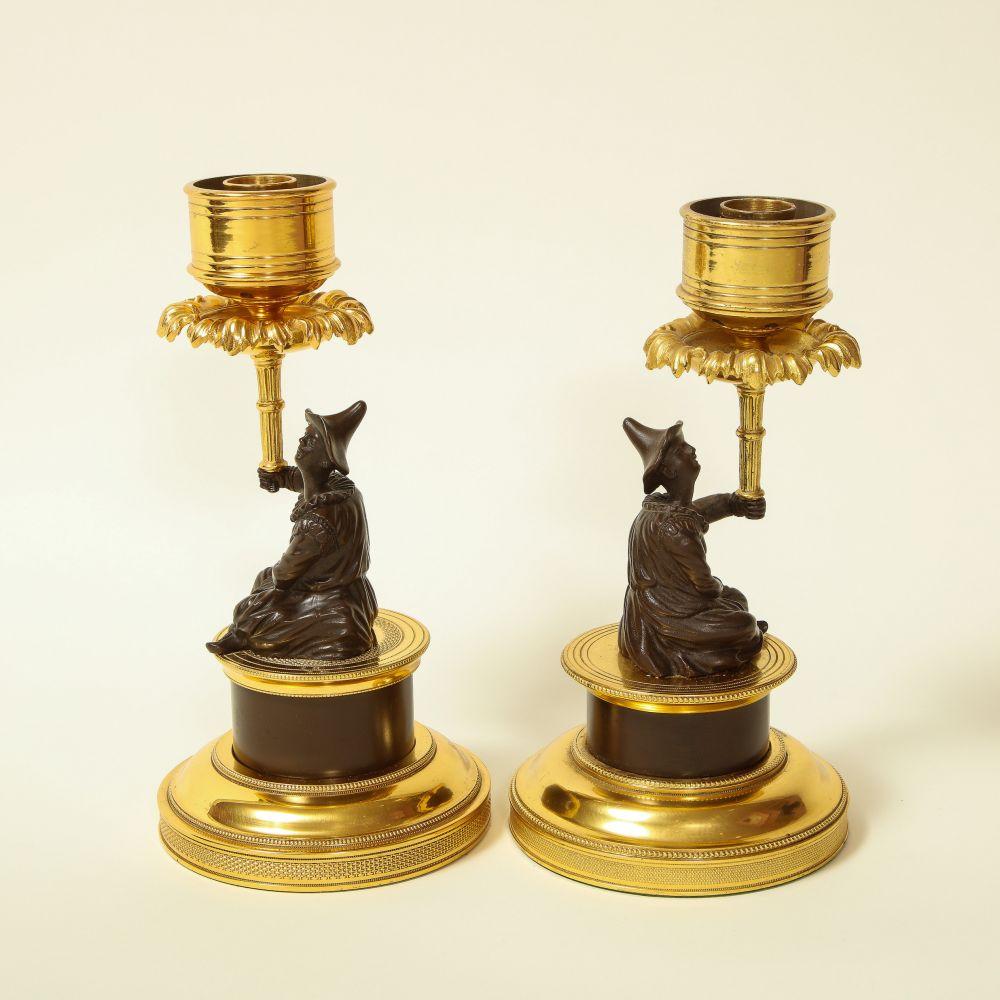 Pair of Louis XVI Style Harlequin Figural Bronze and Gilt-Bronze Candlesticks In Excellent Condition For Sale In New York, NY