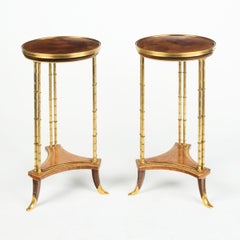A pair of Louis XVI style mahogany and ormolu gueridons, after Adam Weisweiler