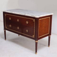 A Pair of Louis XVI style marble top mahogany commodes, signed Jansen, C 1940.