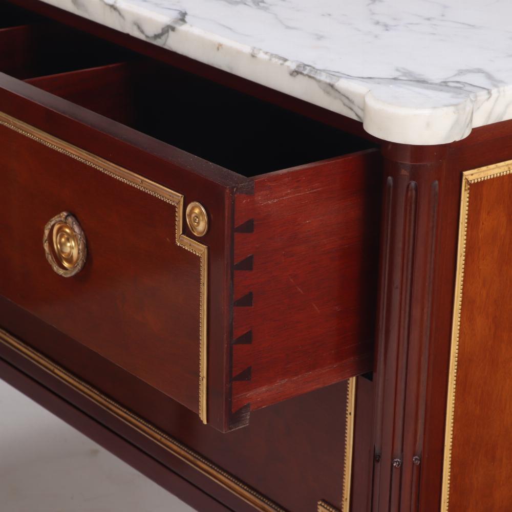 A Pair of Louis XVI style marble top mahogany commodes, signed Jansen, C 1940. In Good Condition For Sale In Philadelphia, PA