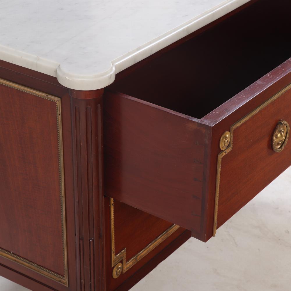 20th Century A Pair of Louis XVI style marble top mahogany commodes, signed Jansen, C 1940. For Sale