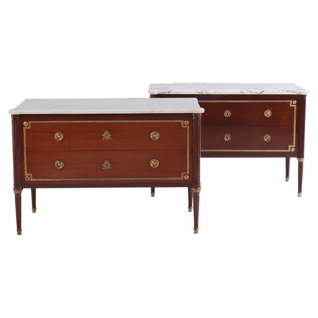A Pair of Louis XVI style marble top mahogany commodes, signed Jansen, C 1940. For Sale