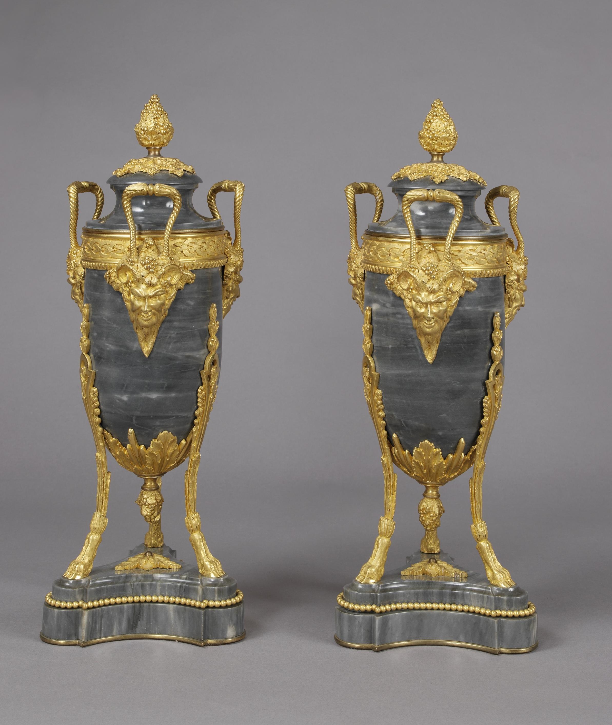 A fine pair of Louis XVI style gilt bronze-mounted Bleu Turquin marble urns with Satyr masks, attributed to Maxime Secrétant. 

French, circa 1890. 

The bronze mounts stamped with inter-linked monogram 'SM, 818', one with 'JJ'.

Maxime