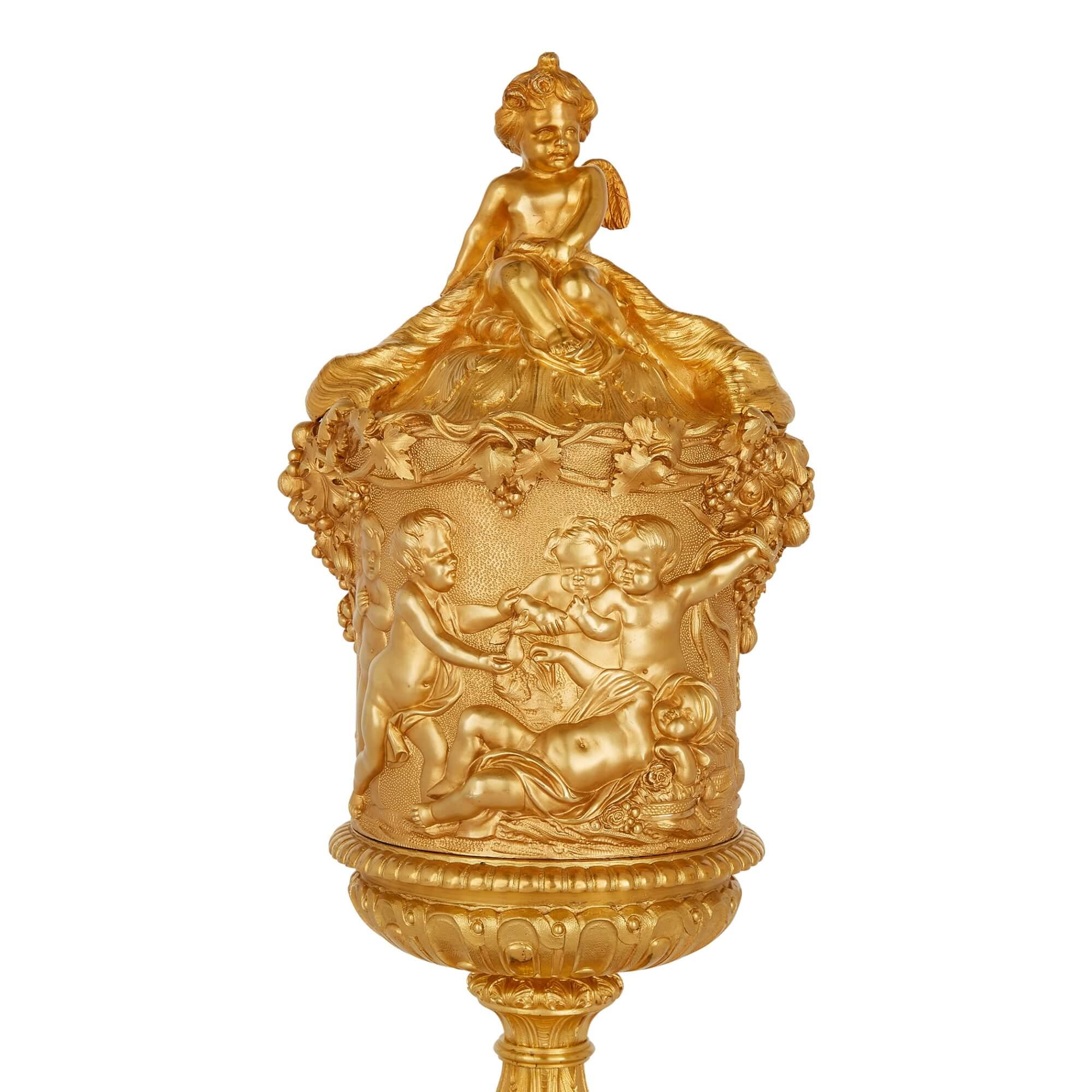 Gilt Pair of Louis XVI Style Ormolu Lidded Urns, Designs in the Style of Clodion
