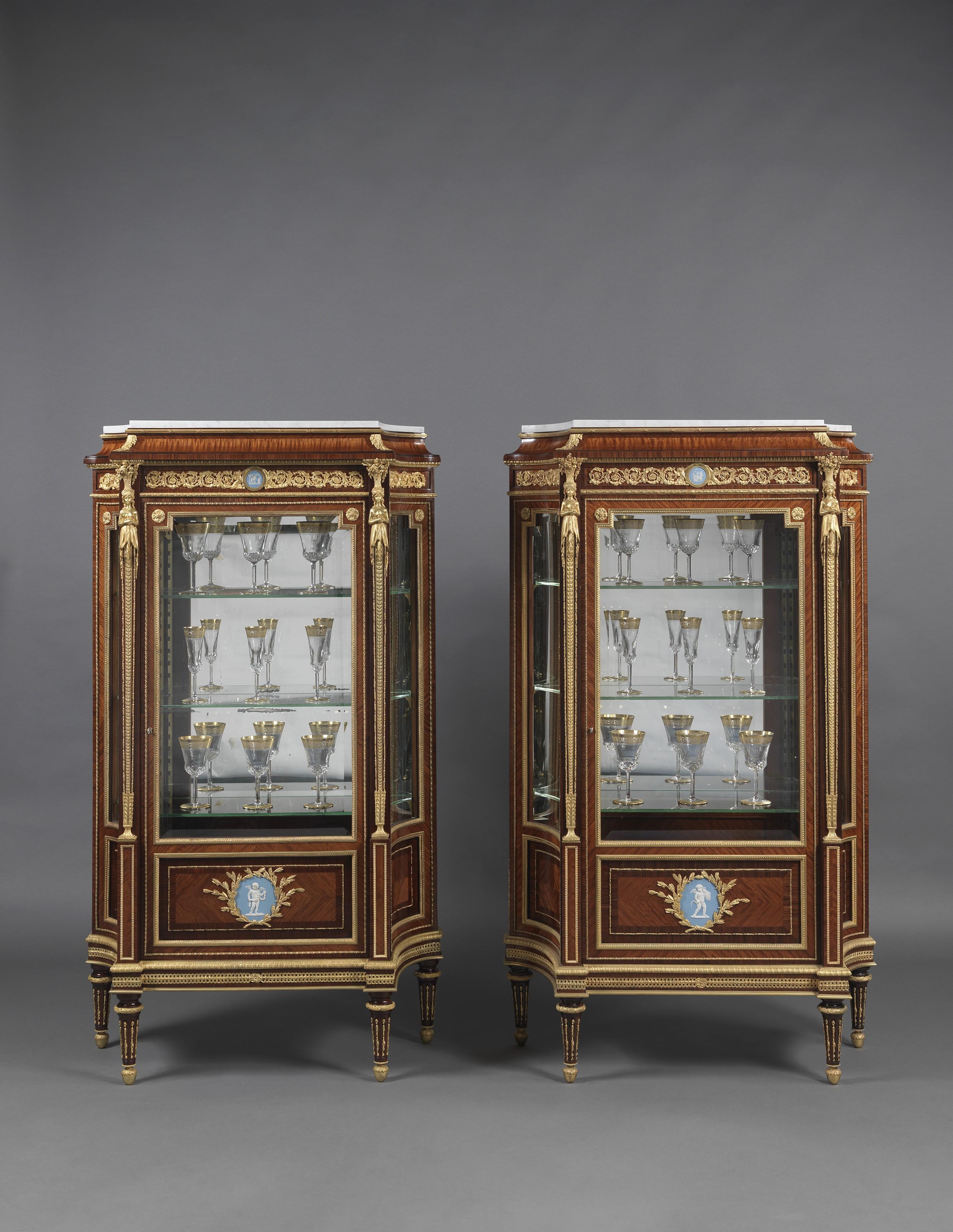 An important pair of Louis XVI style gilt-bronze mounted vitrines with wedgwood Jasperware plaques, by Joseph-Emmanuel Zwiener.

French, circa 1880. 

Stamped 'NZ', 'NZ.309' and 'ZJ' to the reverse of the bronze mounts. 

Signed to the reverse