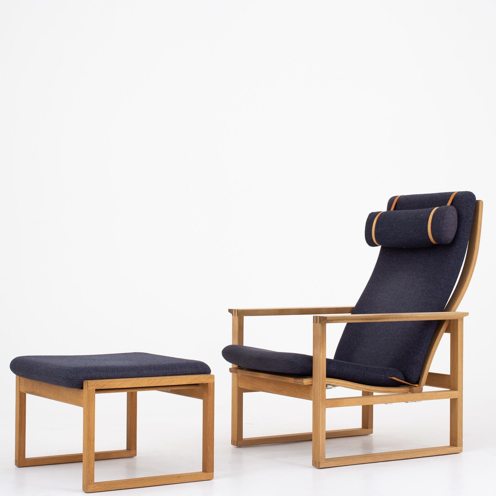 2 lounge chairs with foot stools in soaped oak and original cushions in blue wool. Maker Fredericia Furniture. Designed 1958.