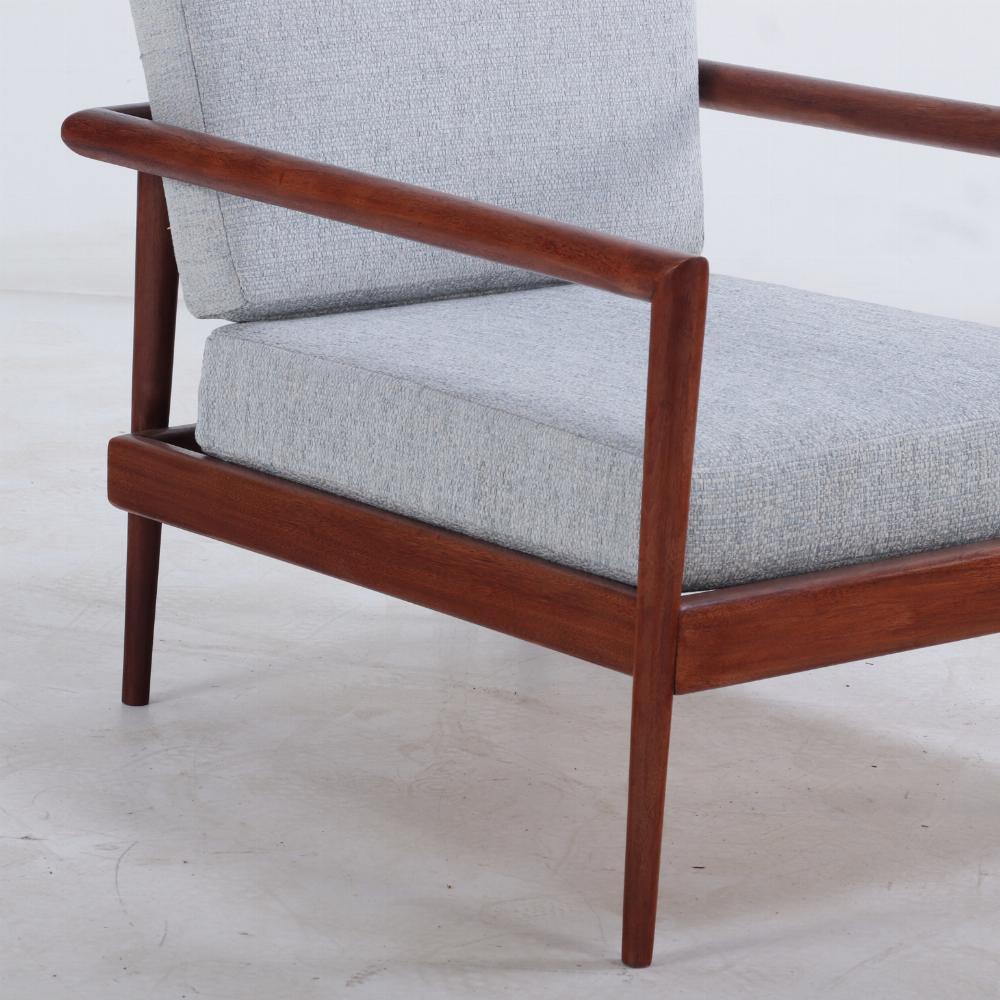 A pair of lounge chairs with Windsor backs designed by Edmund Spence. 1