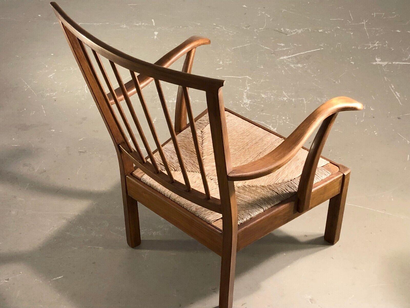 A beautiful pair of low armchairs, Rustic-Modern, Brutalist, Mid-Century Modern, Forme Libre, geometrical structures in massive cherry wood, with removable seats in straw and large aerial backrests in cherry wood, to be attributed, France
