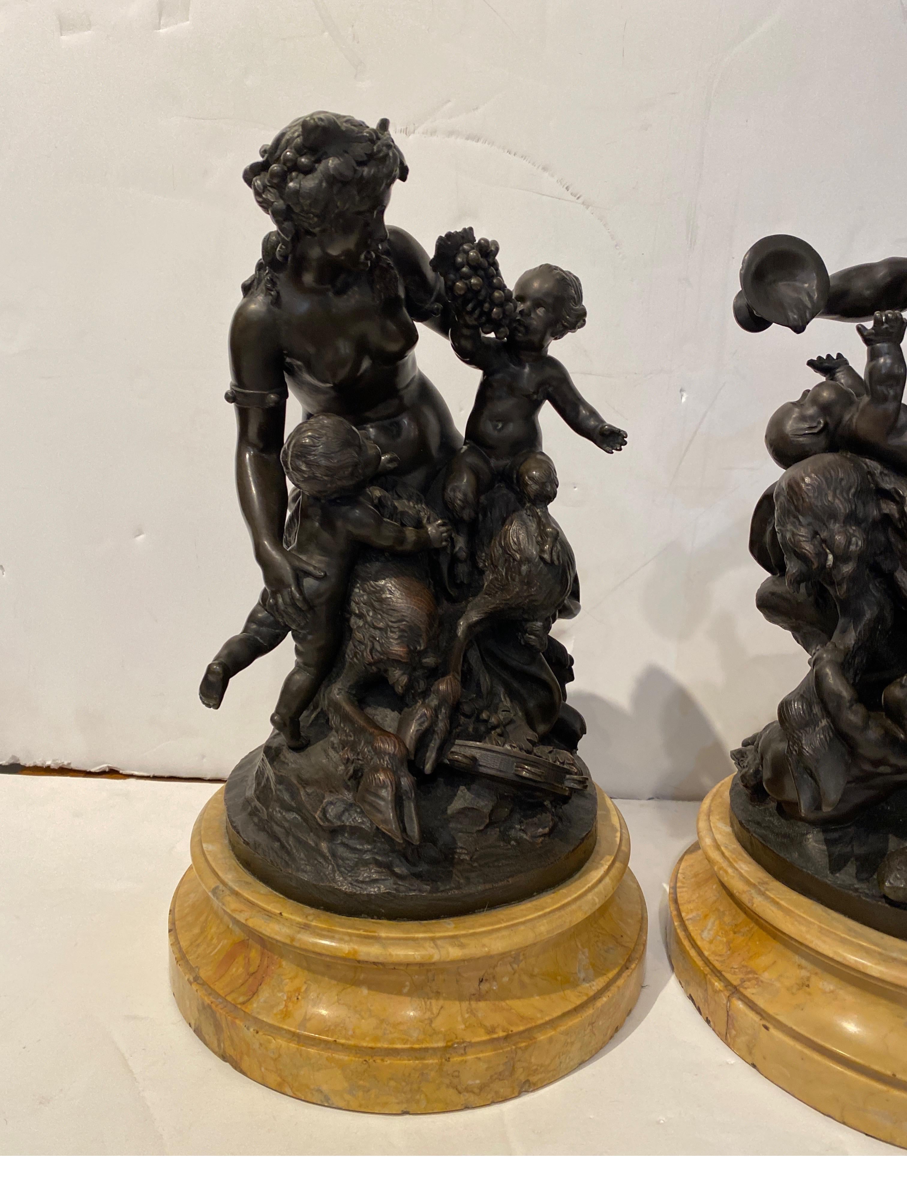 A Pair of 19th Century Grand Tour bronzes after the original sculptor, Claude Michael Clodion. The male and female Satyr Bacchus themes with putti and the adult figures with an original dark patination with attached original sienna marble round