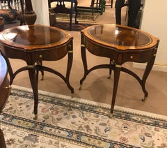 A Pair of Mahogany and Leather Oval End Tables