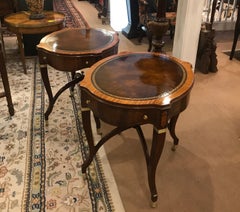 A Pair of Mahogany and Leather Oval End Tables