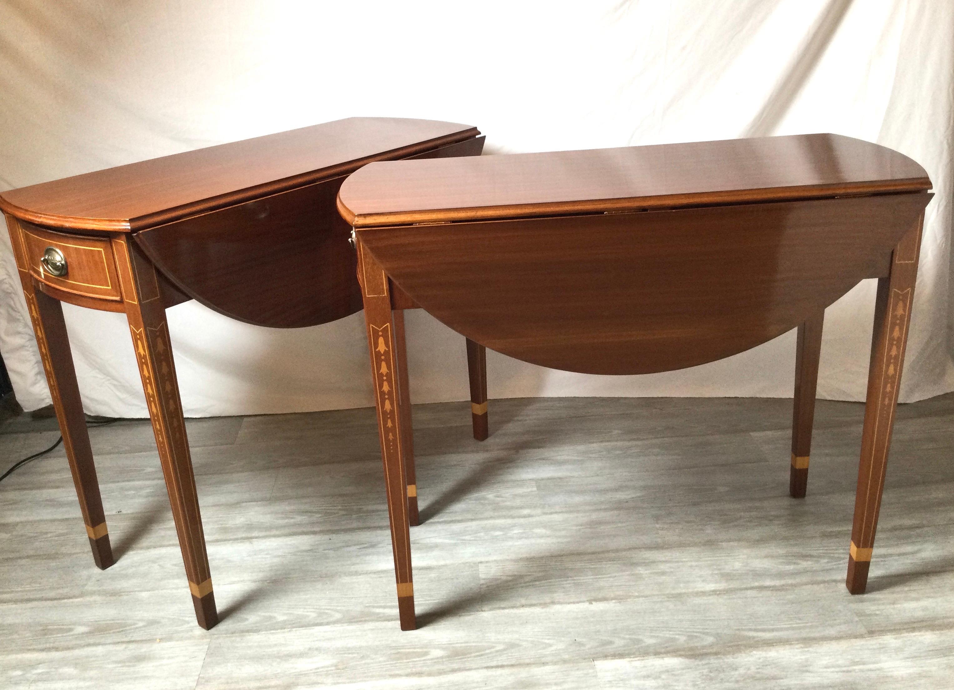 A pair of large scale mahogany Pembroke tables with satinwood inlay of bell flowers with pencil inlay. 33 inches tall, 39.5 inches deep and 18 inches wide, 42 inches wide with leaves up.