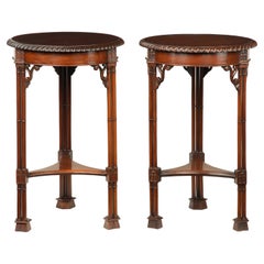 A pair of mahogany circular occasional tables in the Chippendale taste