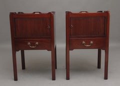 A pair of mahogany tray top bedside cabinets in the Georgian style