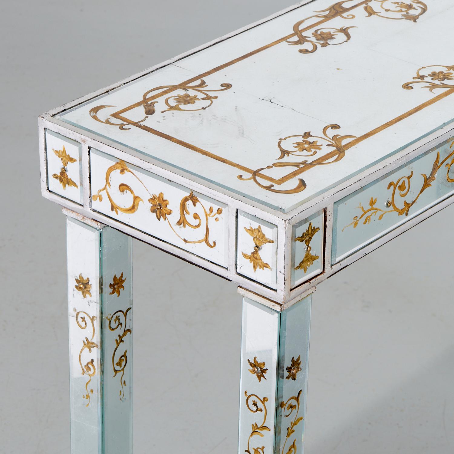 A pair of vintage 20th c., reverse painted mirrored glass console tables decorated with gilt floral scrolls, unmarked, possibly Maison Jansen.

This pair of delightfully dainty tables are beautifully painted. Though certainly showstoppers, there is
