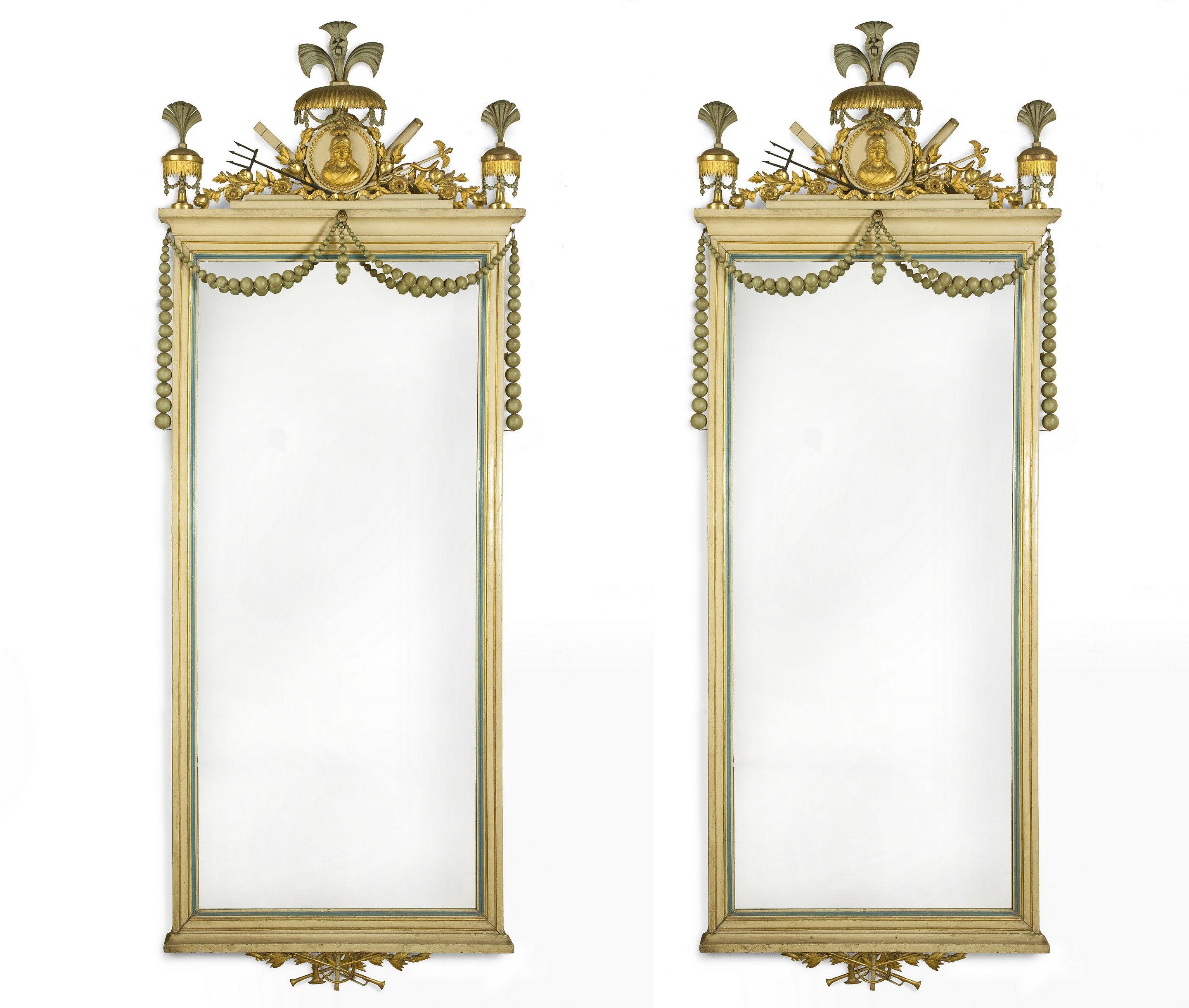 The rectangular mirrors are surmounted by and allegorical crest and hung with strings of graduated beads, painted in cream, blue and grey with gilding.
