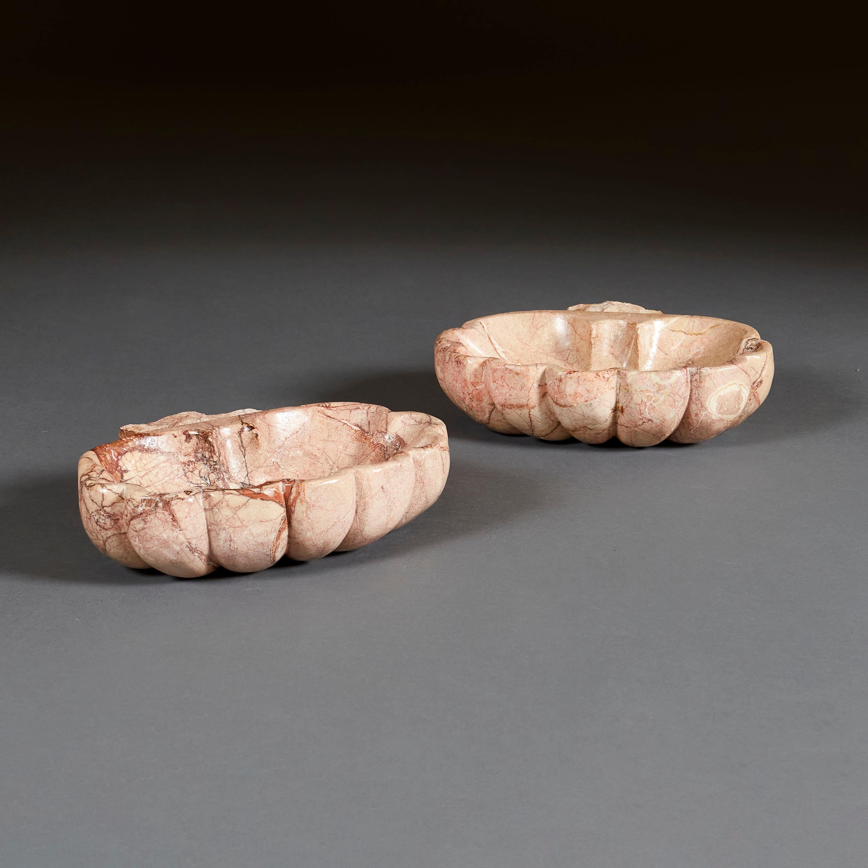 A pair of mid eighteenth century Italian pink marble basins of scallop shell form.