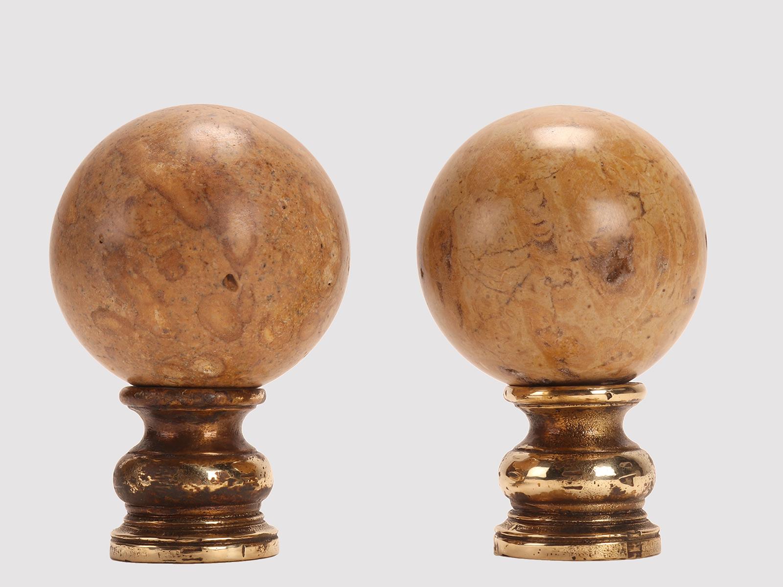A pair of marine fossil “Mothership” spheres, resting on a base, made of brass. Italy circa 1890.