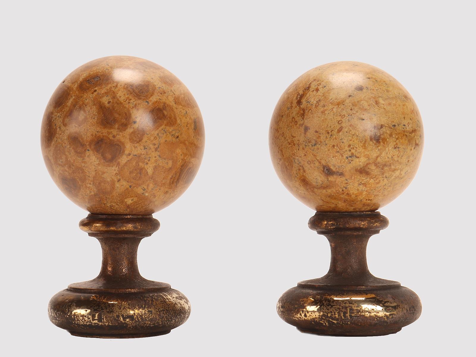 A pair of marine fossil “Mothership” spheres, resting on a base, made of brass. Italy circa 1890.