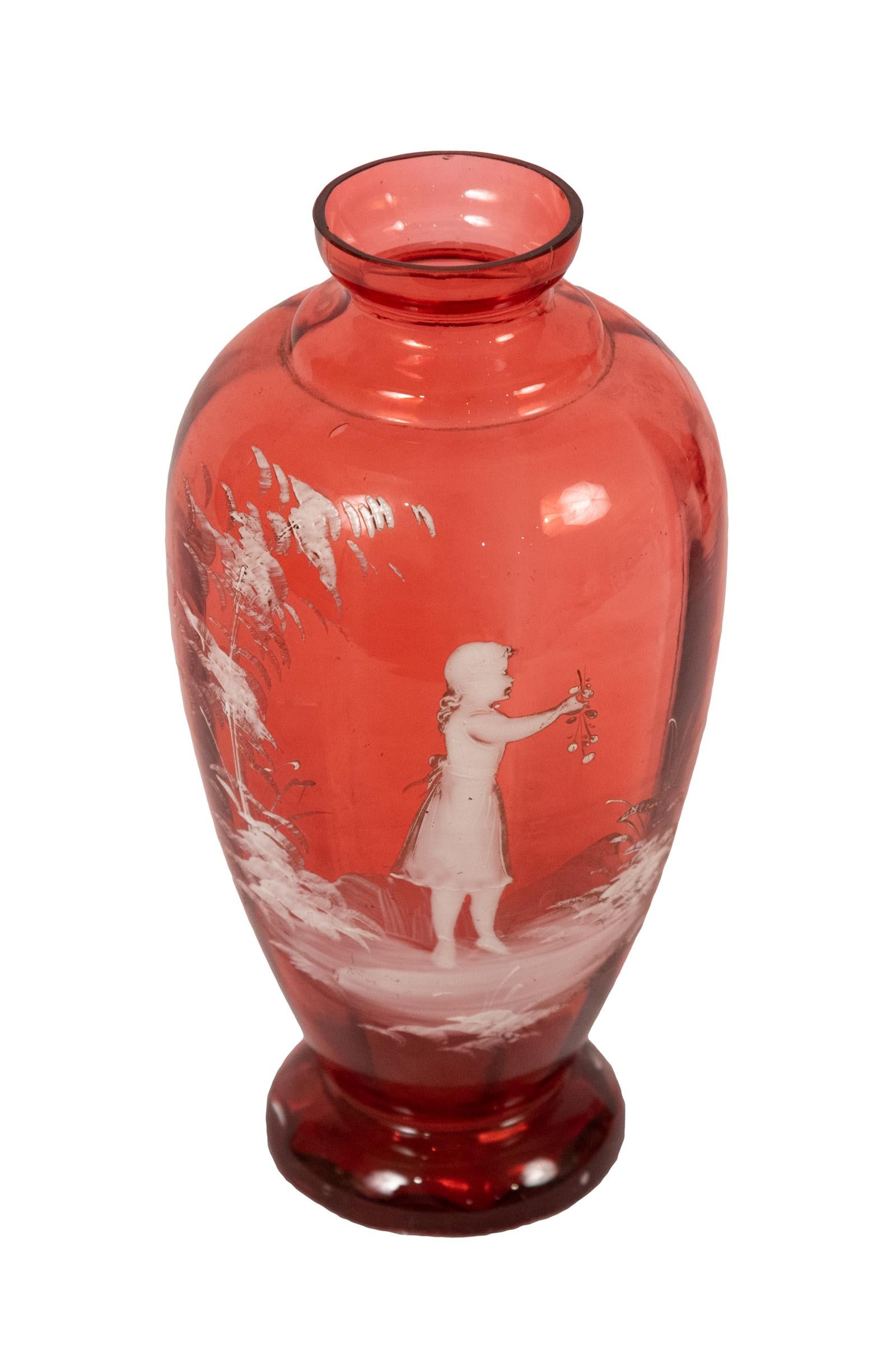 Comprising of two Mary Gregory cranberry enameled vases. Each finely enameled with children within a landscape.