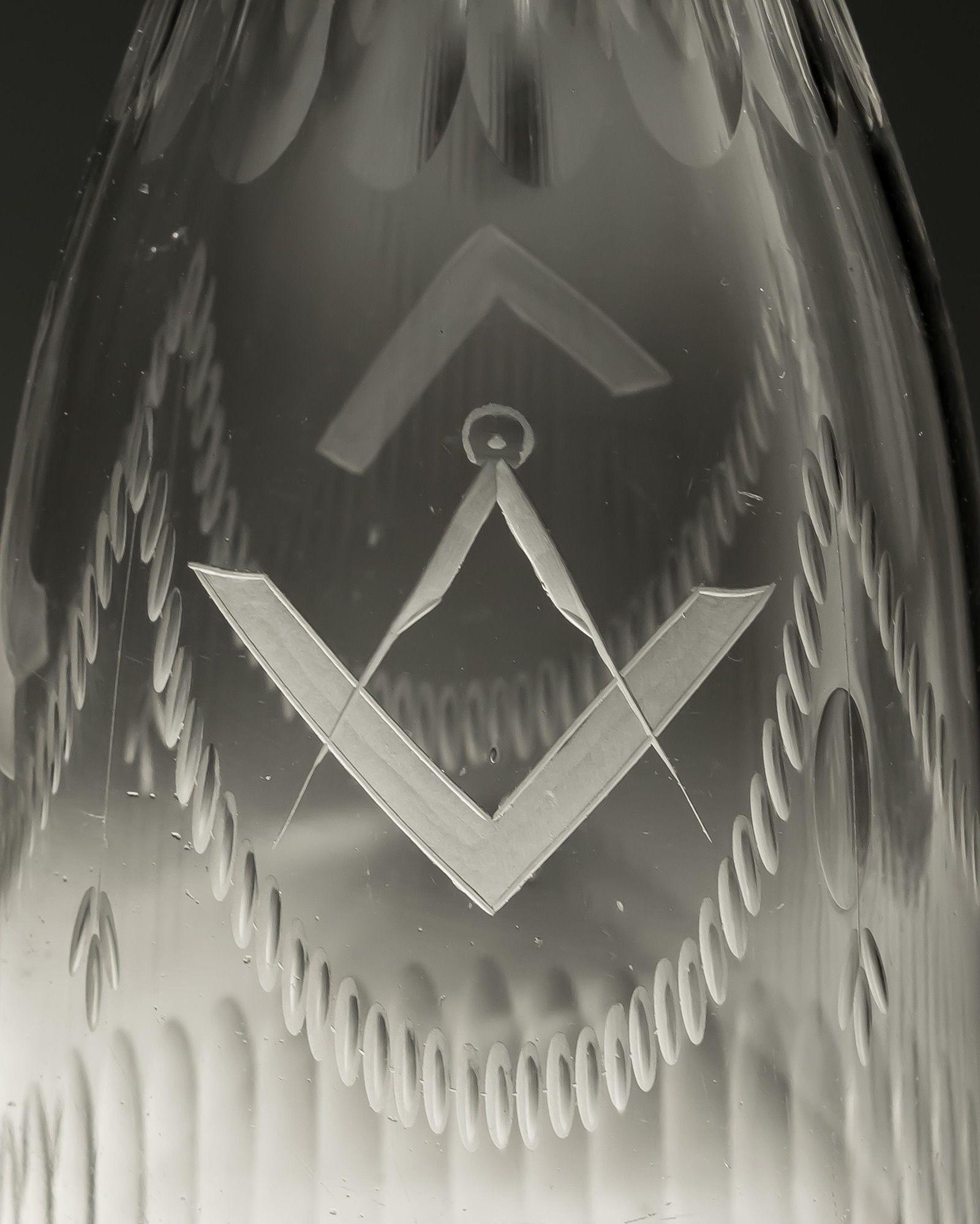 A pair broad and fine flute cut tapered decanters engraved with Masonic interest fitted with heart shaped stoppers.