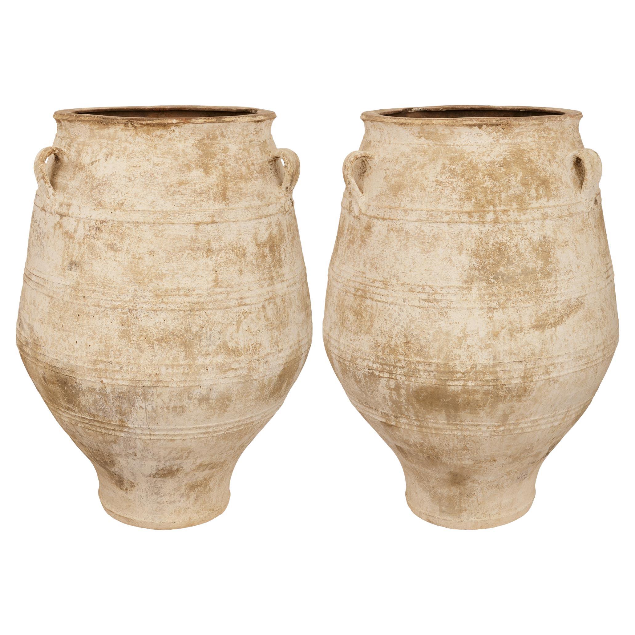 A pair of Mediterranean 19th century patinated Terra Cotta olive jars