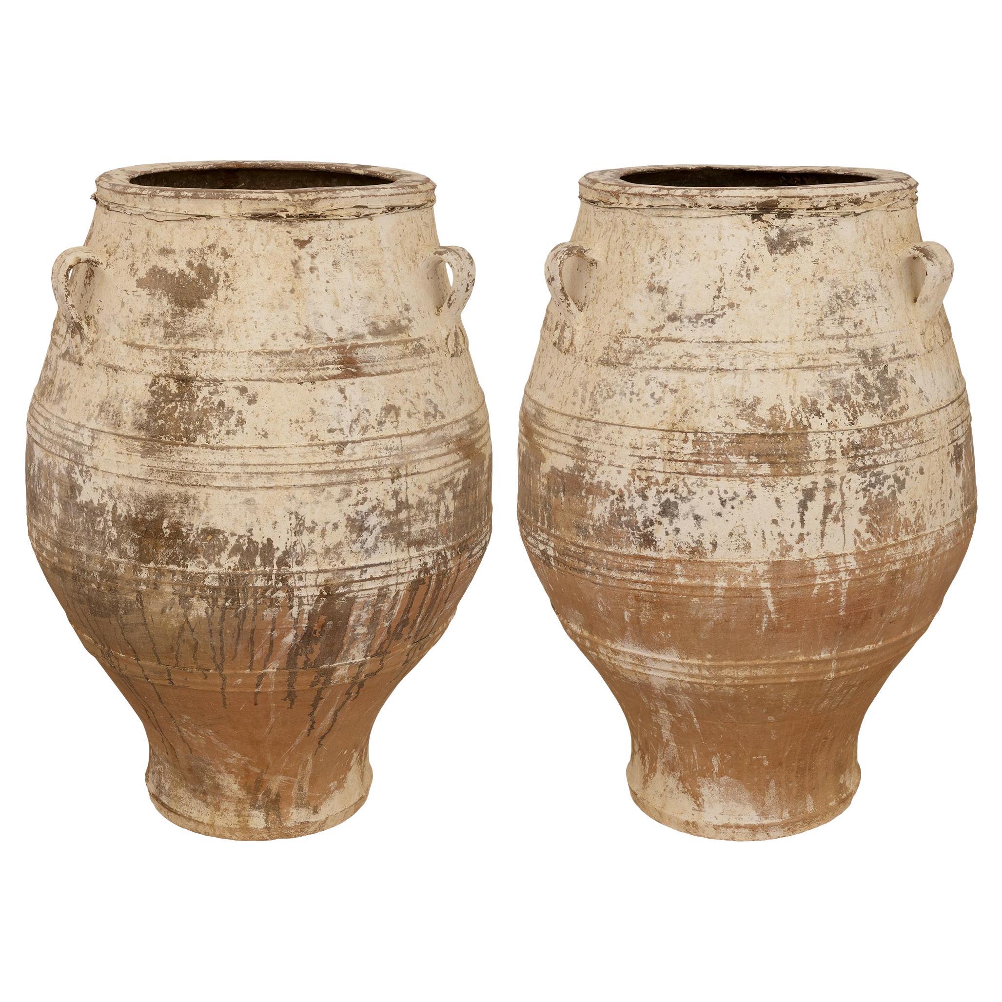 A pair of Mediterranean 19th century patinated Terra Cotta olive jars