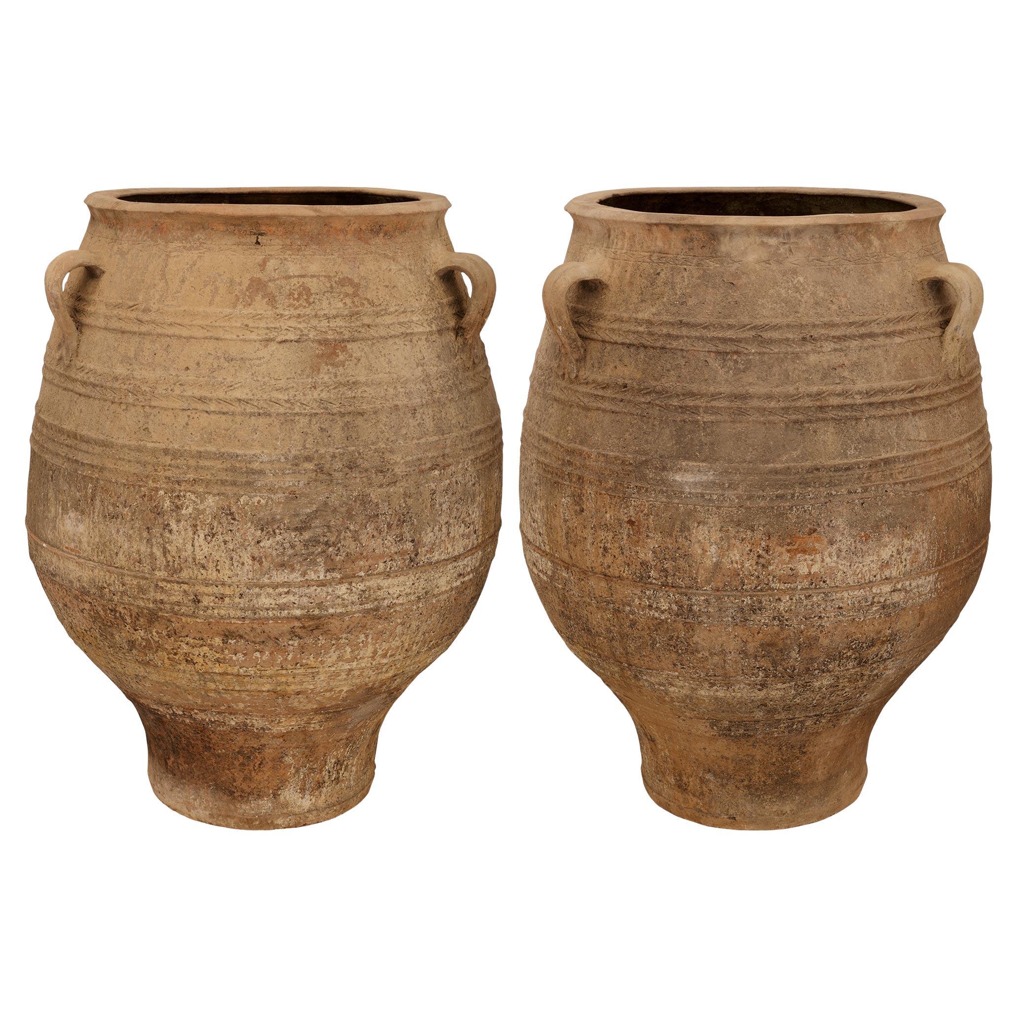 A pair of Mediterranean 19th century patinated Terra Cotta olive jars