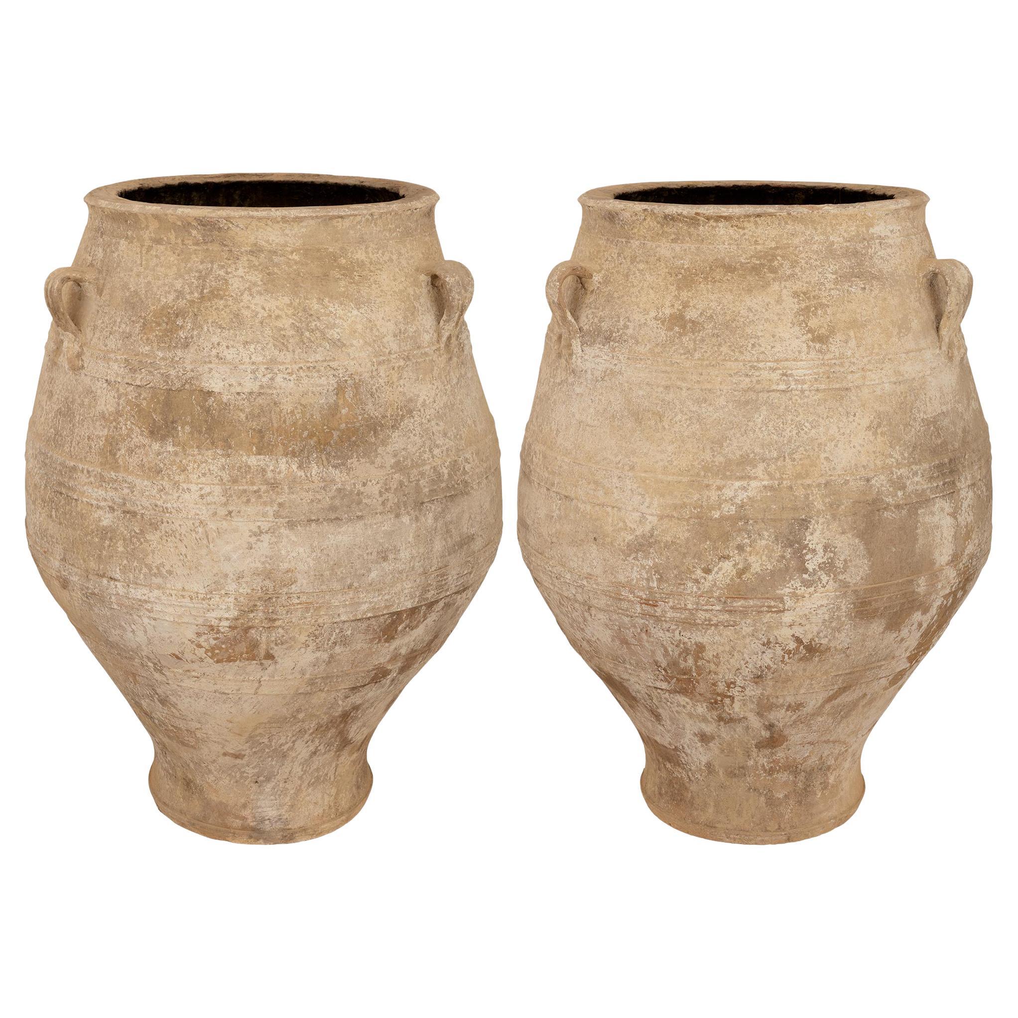 A pair of Mediterranean 19th century patinated Terra Cotta olive jars