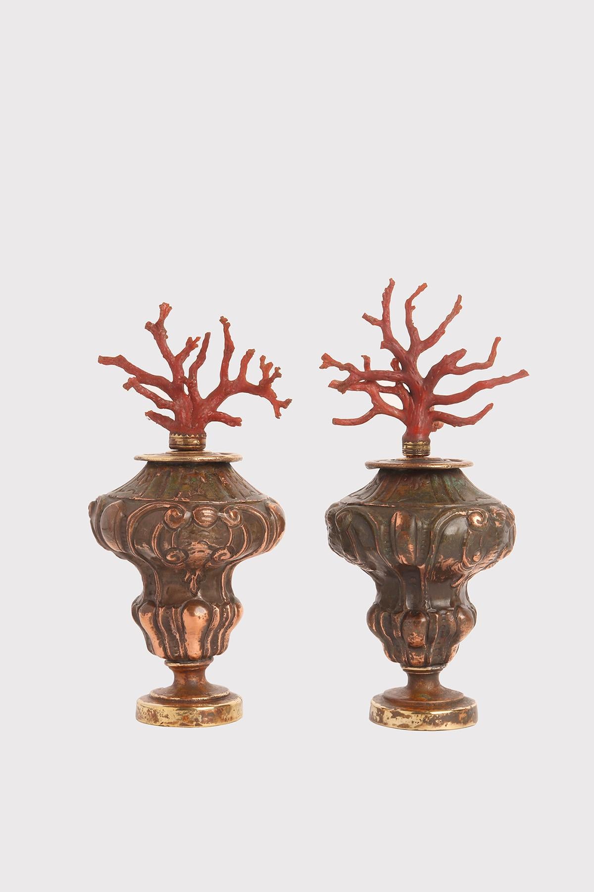 Ein Naturalienexemplar: ein Paar rote Korallenäste aus dem Mittelmeerraum (Coralium Rubrum), montiert auf vasenförmigen Sockeln aus geprägtem Kupfer. Italien um 1870.