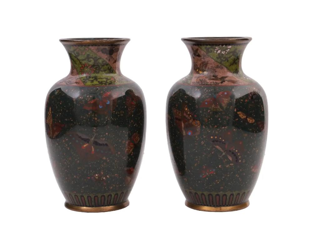 Attributed to Namikawa Yasuyuki, 1845 to 1927, a pair of rare identical antique Japanese, late Meiji era, enamel vases. Each vase has an urn shaped body and a wide fluted neck. The bodies of the vases are adorned with polychrome images of