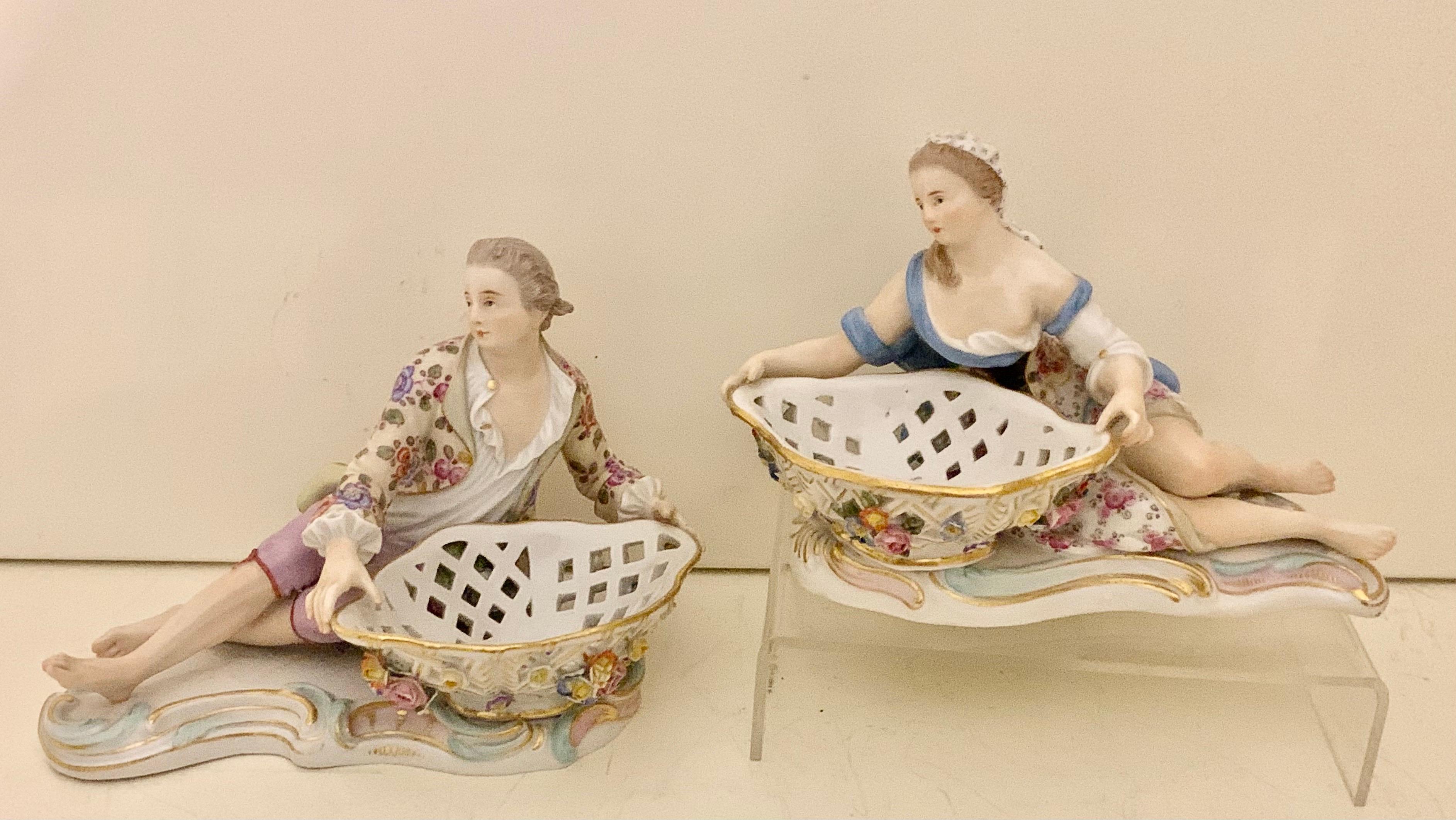 A pair of 19th century Meissen porcelain sweet meat dishes decorated a reclining lady and gentleman the base with crossed sword mark and impressed 2872, the ladies base impressed 2875. Presented in very good condition.