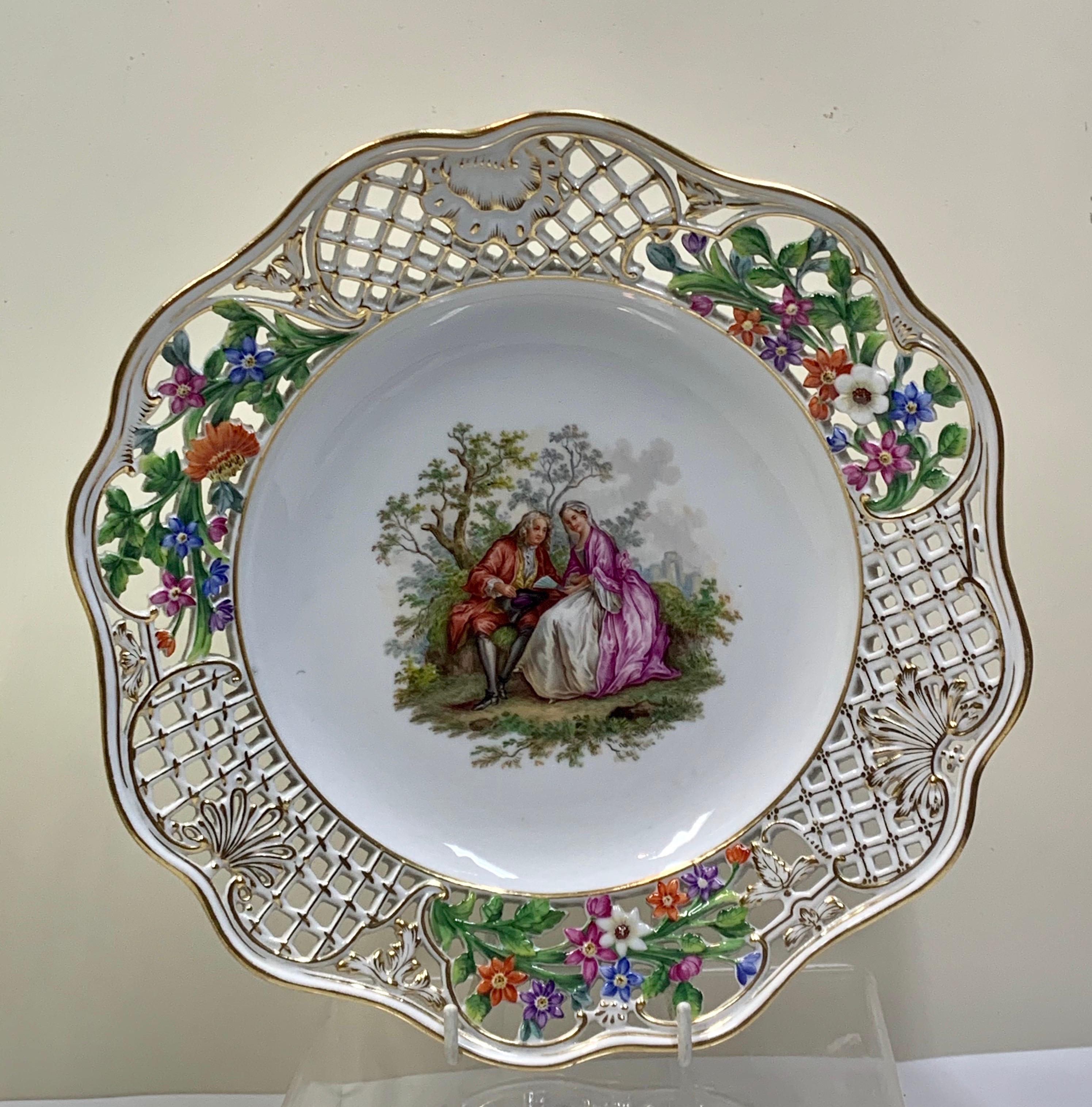 A pair of late Meissen reticulated Plates with floral and lattice moulded rim, central panel of lady and gentleman in a landscape, 8 1/2in D
They are in immaculate condition and have been well cherished all the gilt is still very strong with no