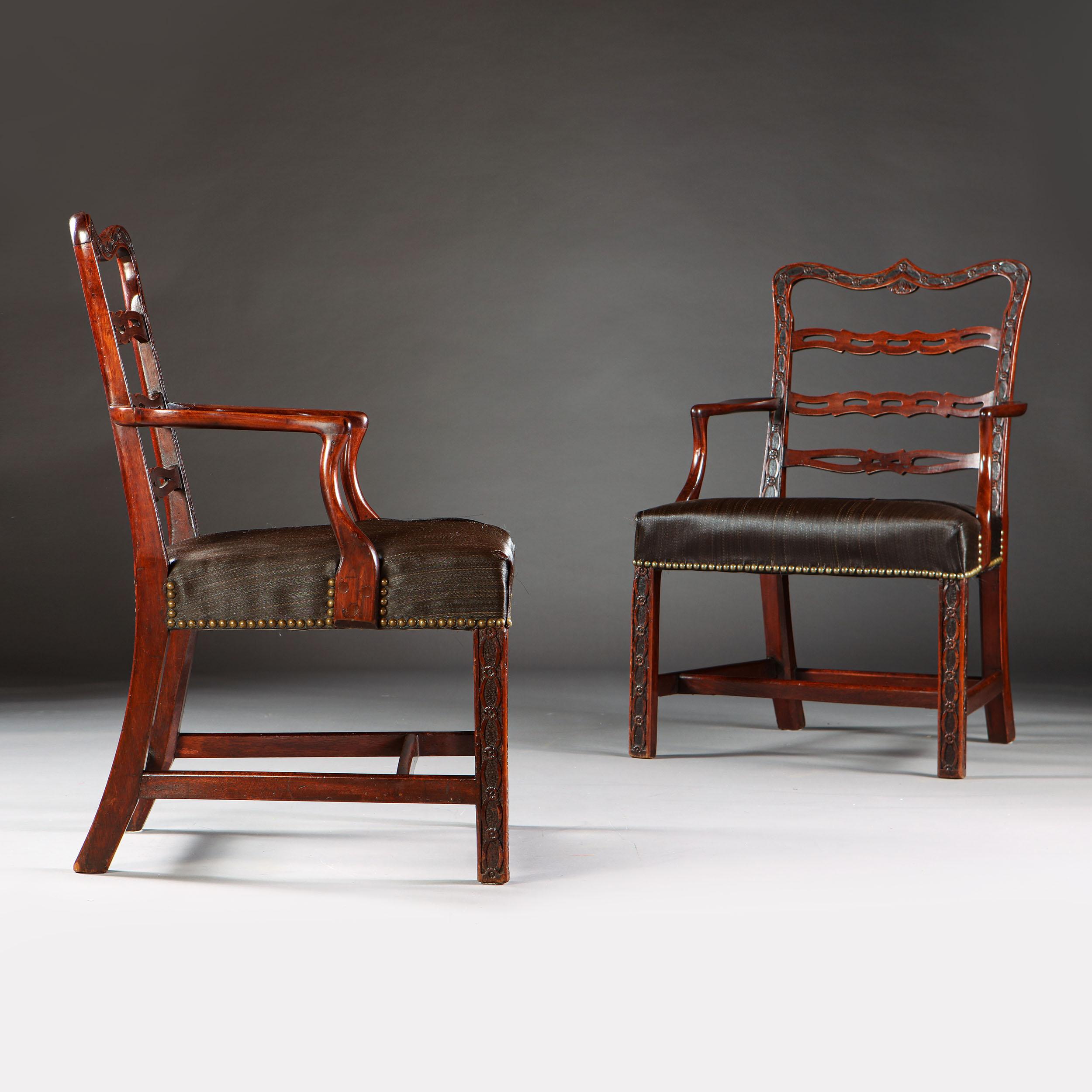 A fine pair of mid 18th century Irish Chippendale chairs with Gothic back rail , ladder back splats decorated throughout with interlocking paterae upholstered horsehair seats. 

Please note: Chairs will require re upholstering.