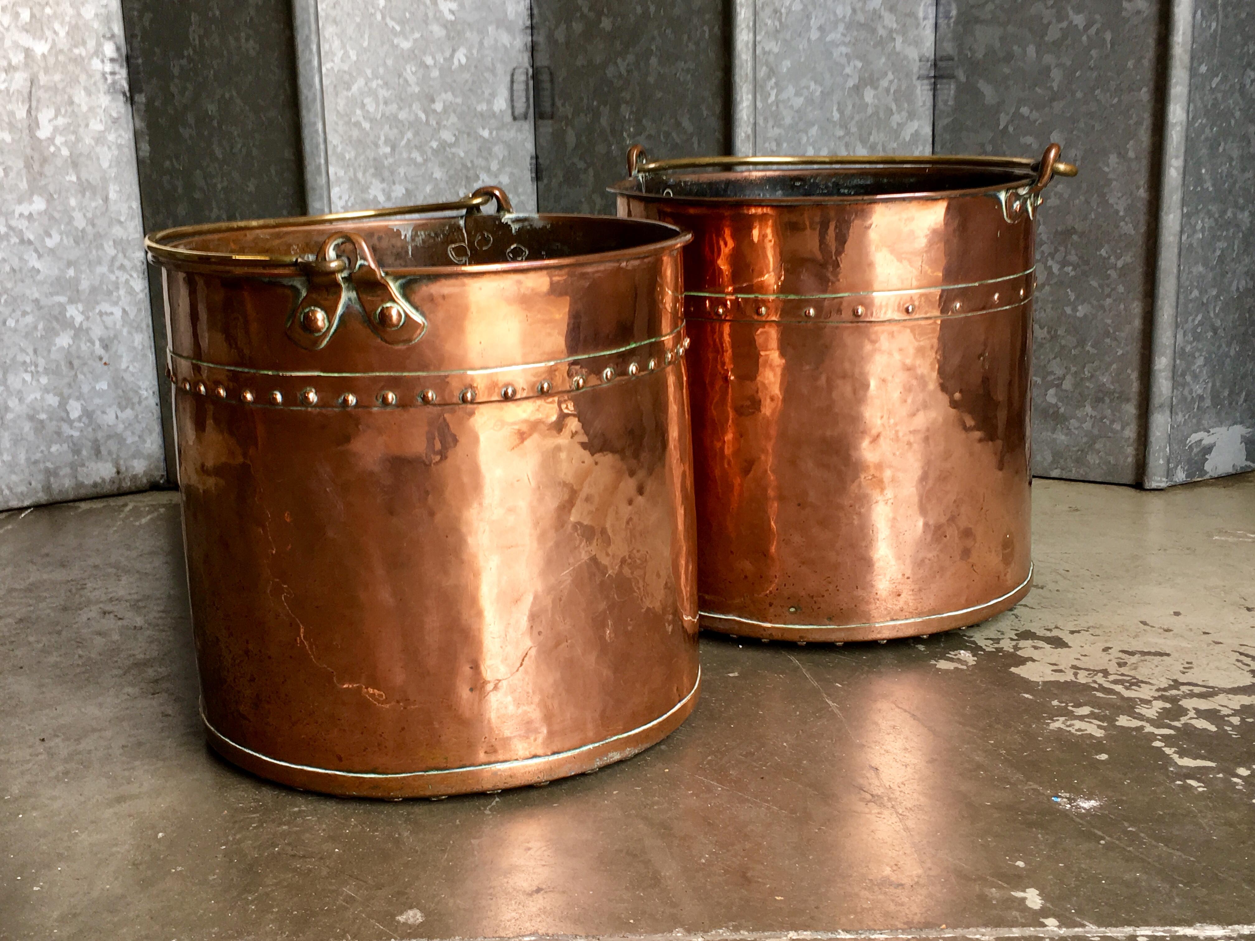 Copper riveted log buckets with brass loop handles. Typical Victorian over engineered riveted seams.