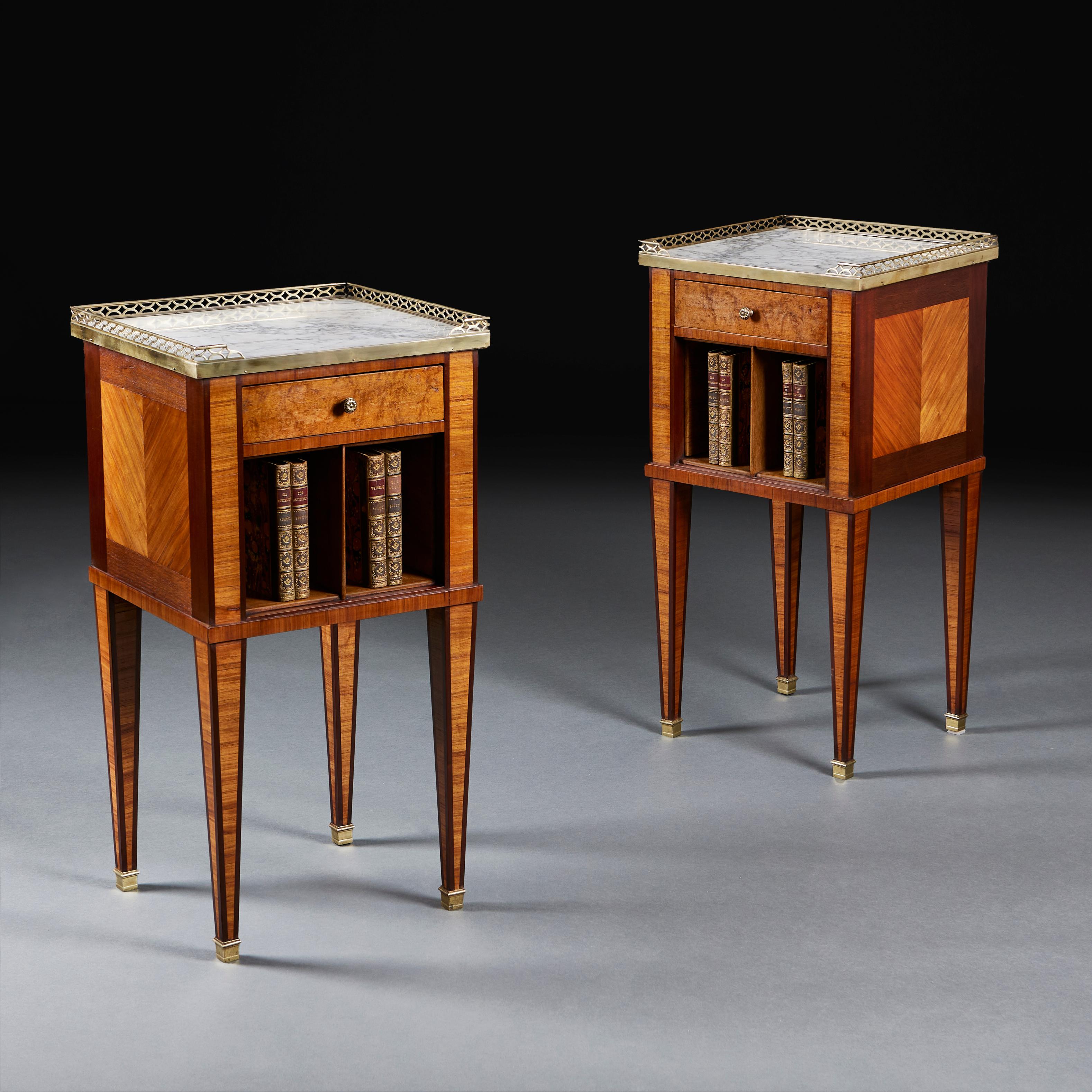 A fine pair of mid nineteenth century kingwood side cabinets, with chevron veneers to the sides, single drawers to the frieze, each with two pigeonholes. The tops with inset white marble, surrounded by pierced brass galleries. 
France, circa