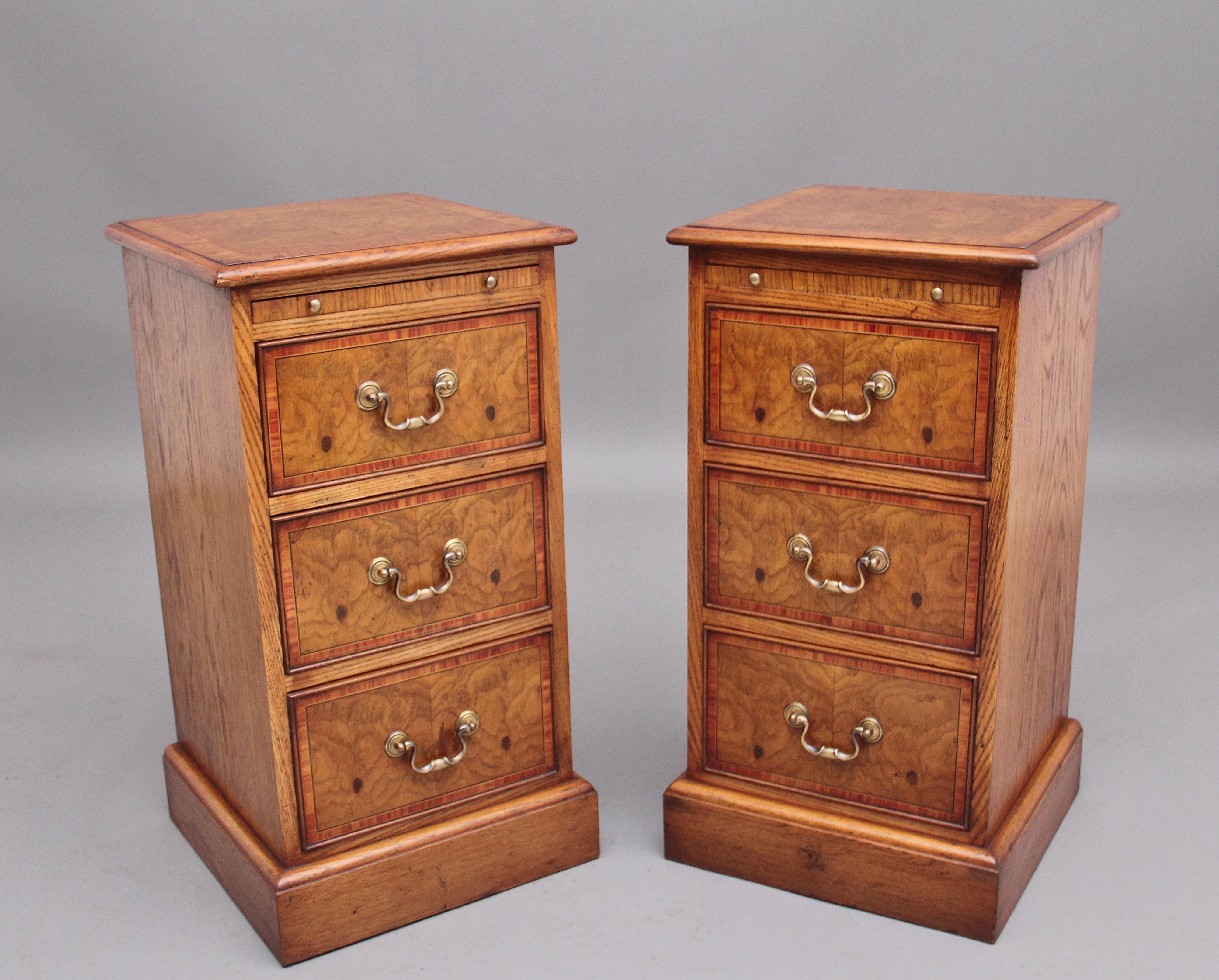 A pair of mid 20th Century burr oak bedside chests, having lovely figured tops, crossbanded and having a moulded edge, fitted pull out slides below and three drawers with crossbanded drawer fronts, brass swan neck handles, supported on a moulded