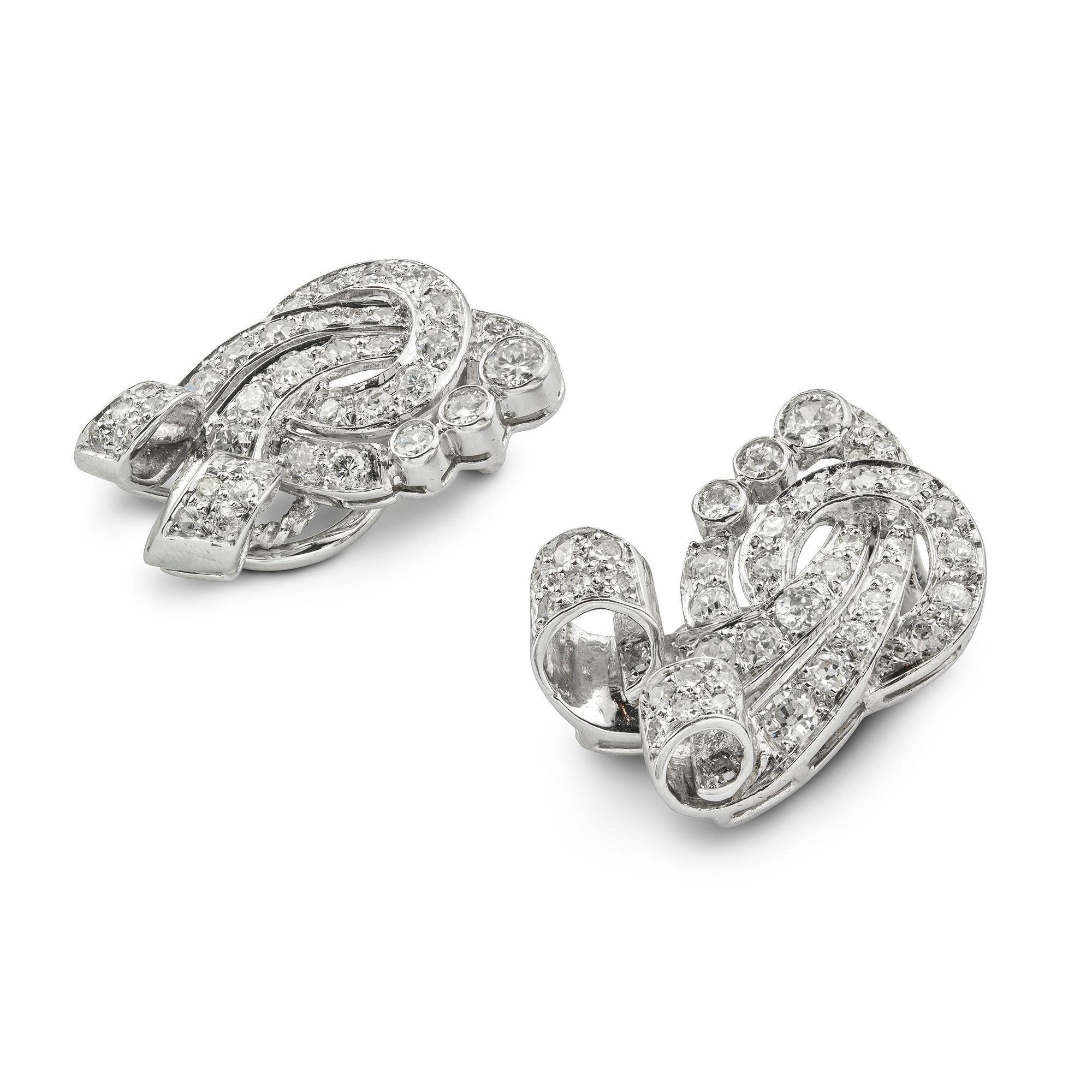 A pair of mid-20th century diamond clip earring, the earrings consisting of a ribbon motif,  set old-cut diamonds estimated to weigh 3 carats in total,all  set to a white gold mount, circa 1950, later hallmarked 18ct gold London, measuring