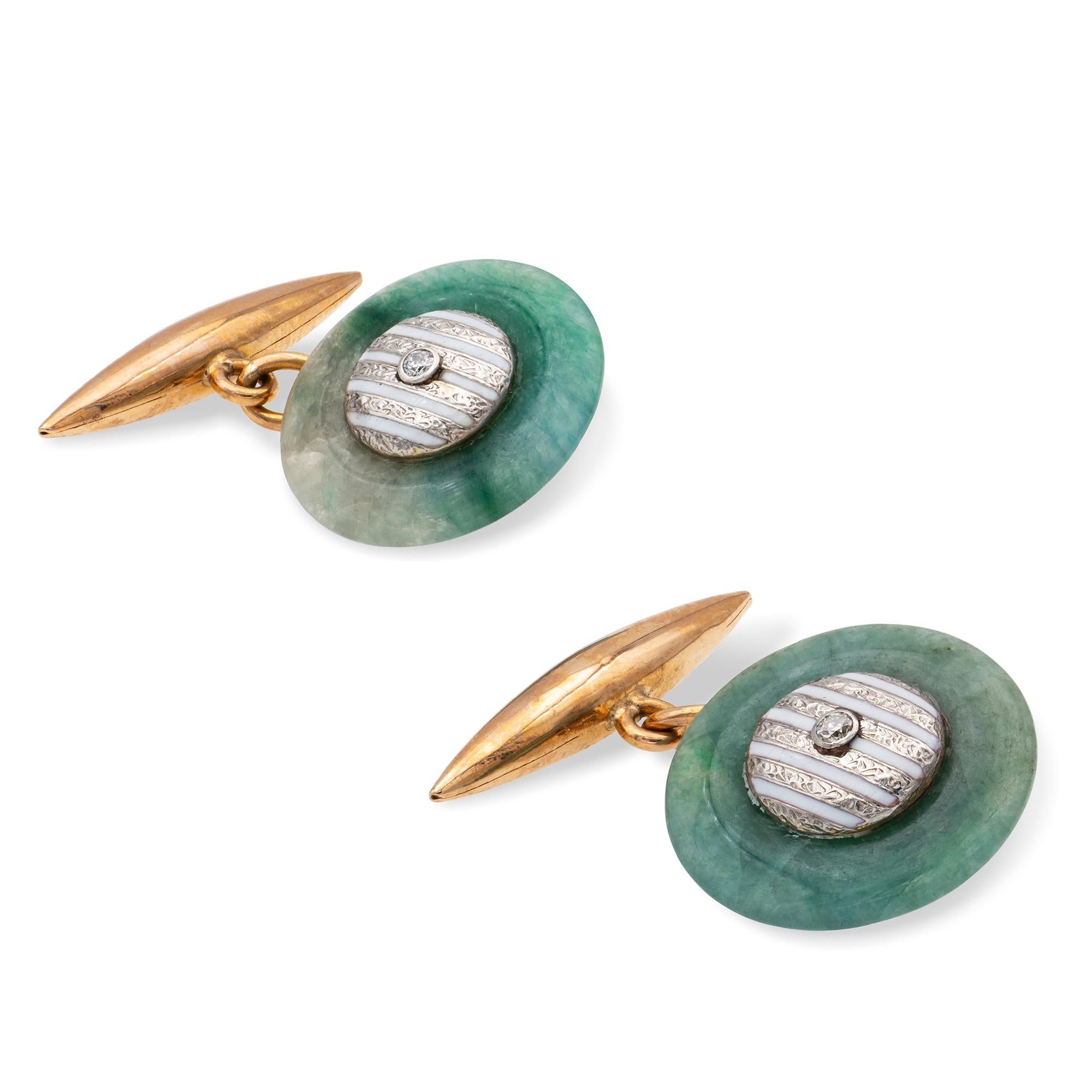 A pair of mid-20th century jade and enamel cufflinks, each link consisting a jade disk centrally set with a round brilliant-cut diamond on a white gold background with white enamel stripes, linked to a yellow gold torpedo-shape bar, circa 1960, the