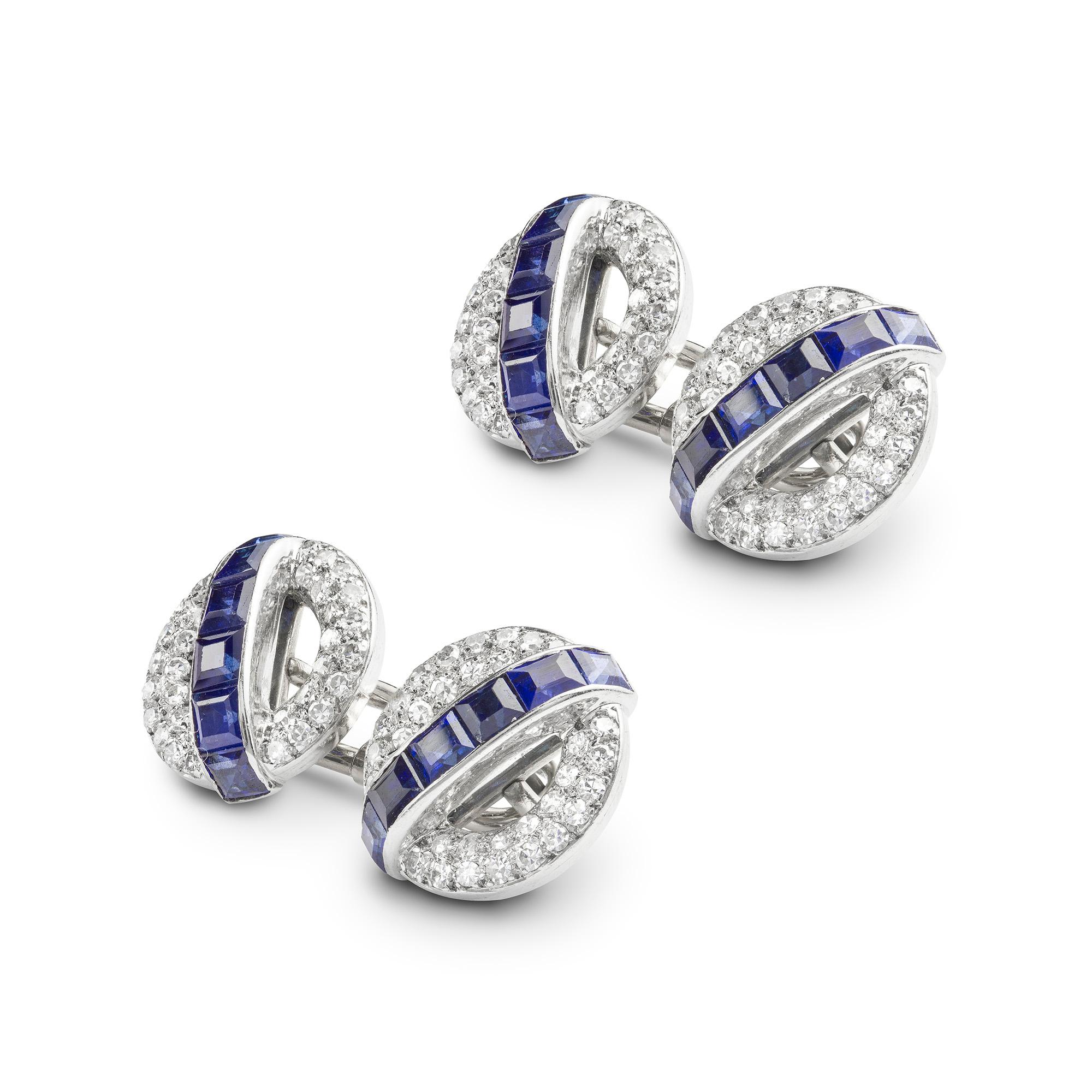 A pair of mid-20th century sapphire and diamond cufflinks, each link set with a central row of square cut sapphires estimated to weigh 4 carats in total, surrounded by a swiss-cut diamond pave-set circle, the diamonds estimated to weight 2.80 carats
