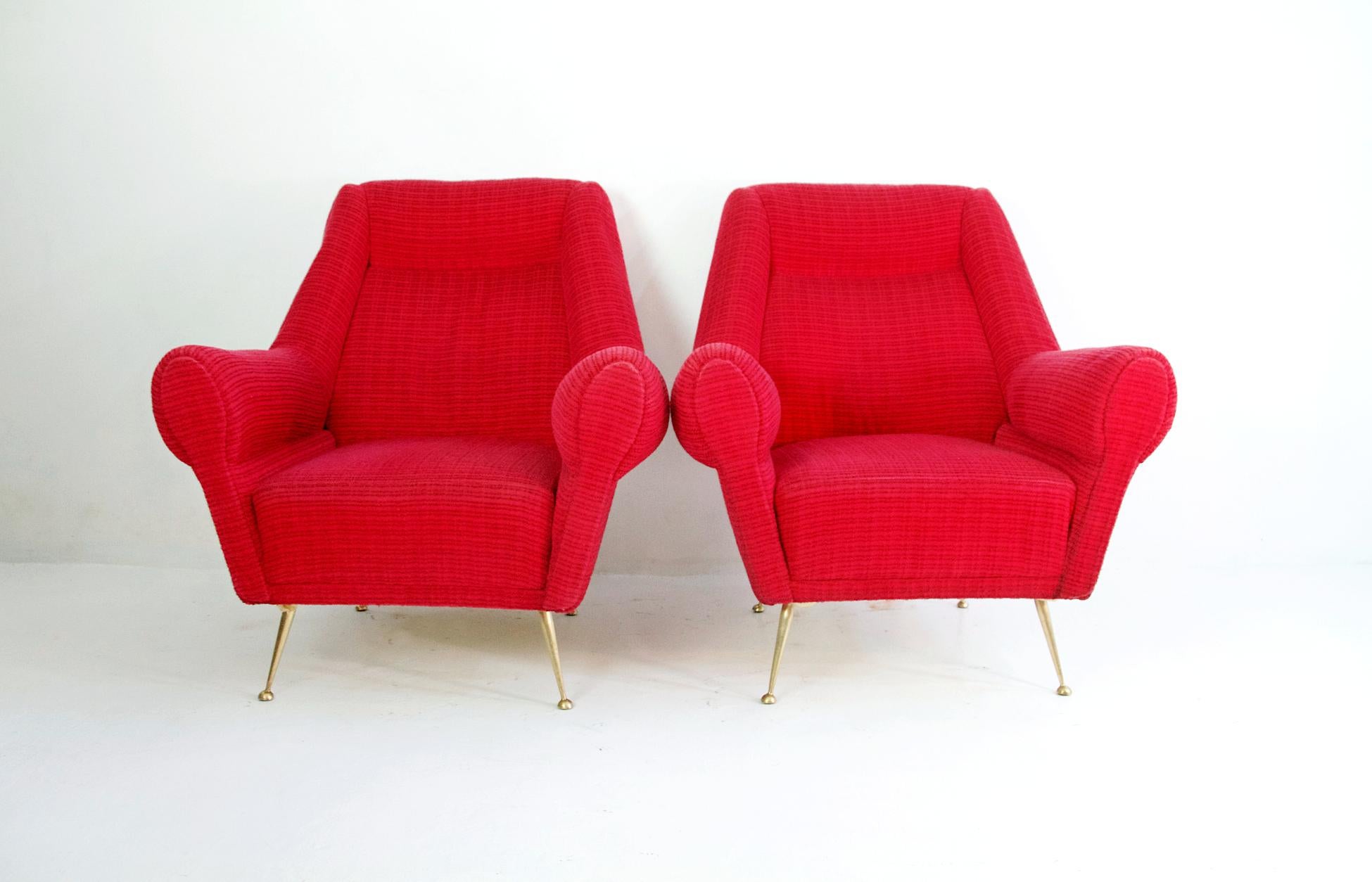 A pair of Italian armchairs designed by Gigi Radice for Minotti produced, circa 1950. The chairs haven’t been reupholstered and retain the original fabric. Legs are in solid brass.
