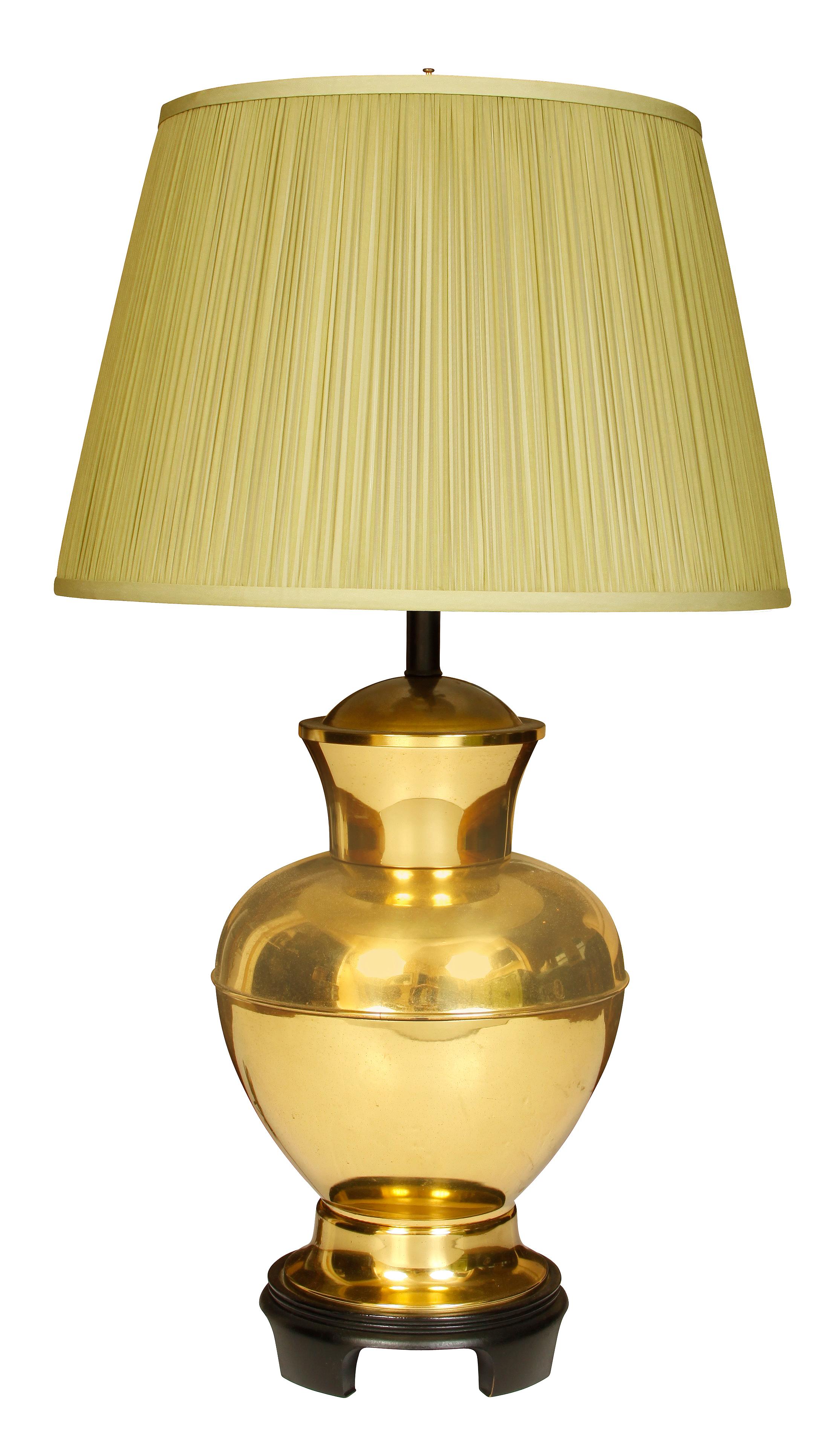 A pair of midcentury round brass lamps with silk shades.