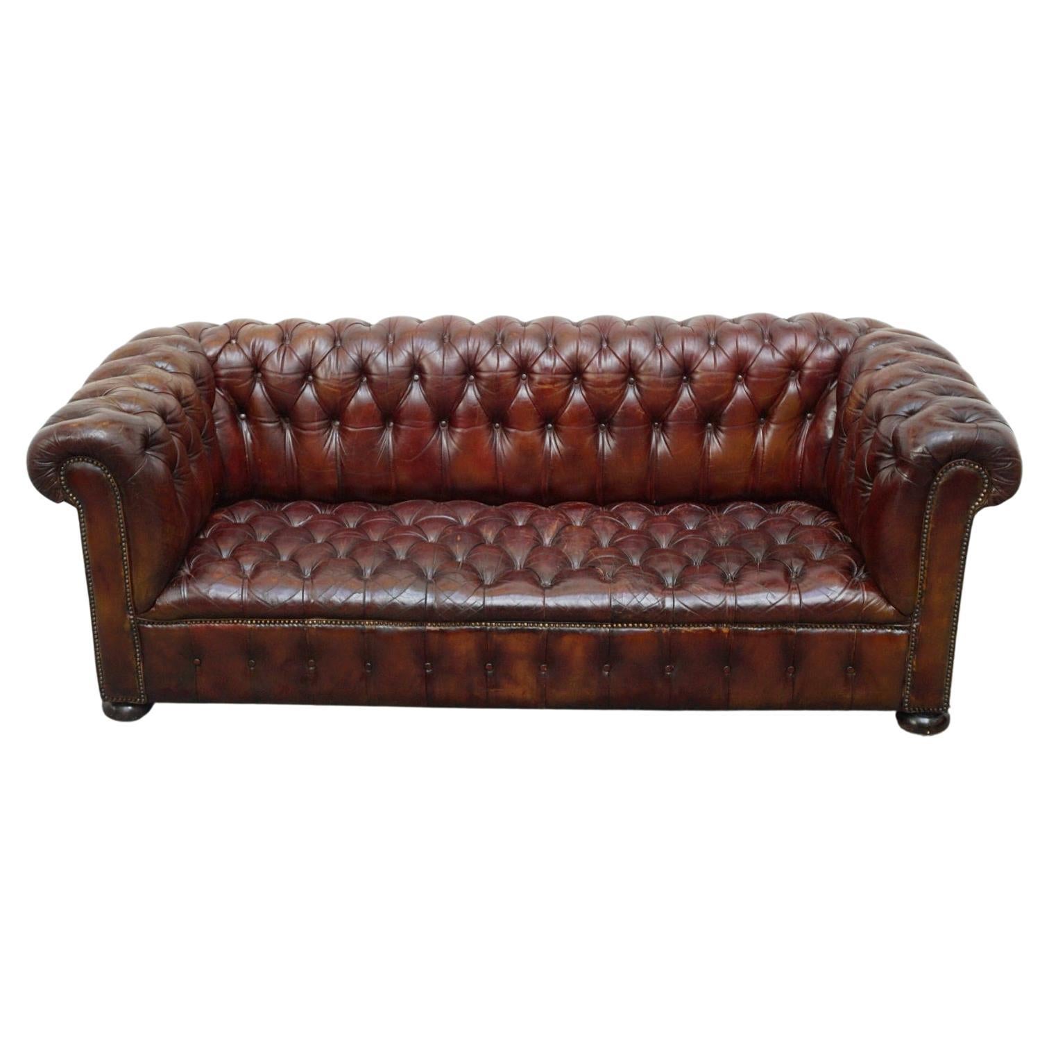 A pair of Mid-Century three seat chesterfield sofas. Upholstered in original buttoned and worn, red brown leather. 

Dimensions: H 73cm W 197cm D 72cm Seat H 35cm W 147cm D 54cm 

Origin: English

Date: Circa 1980

Item Number: