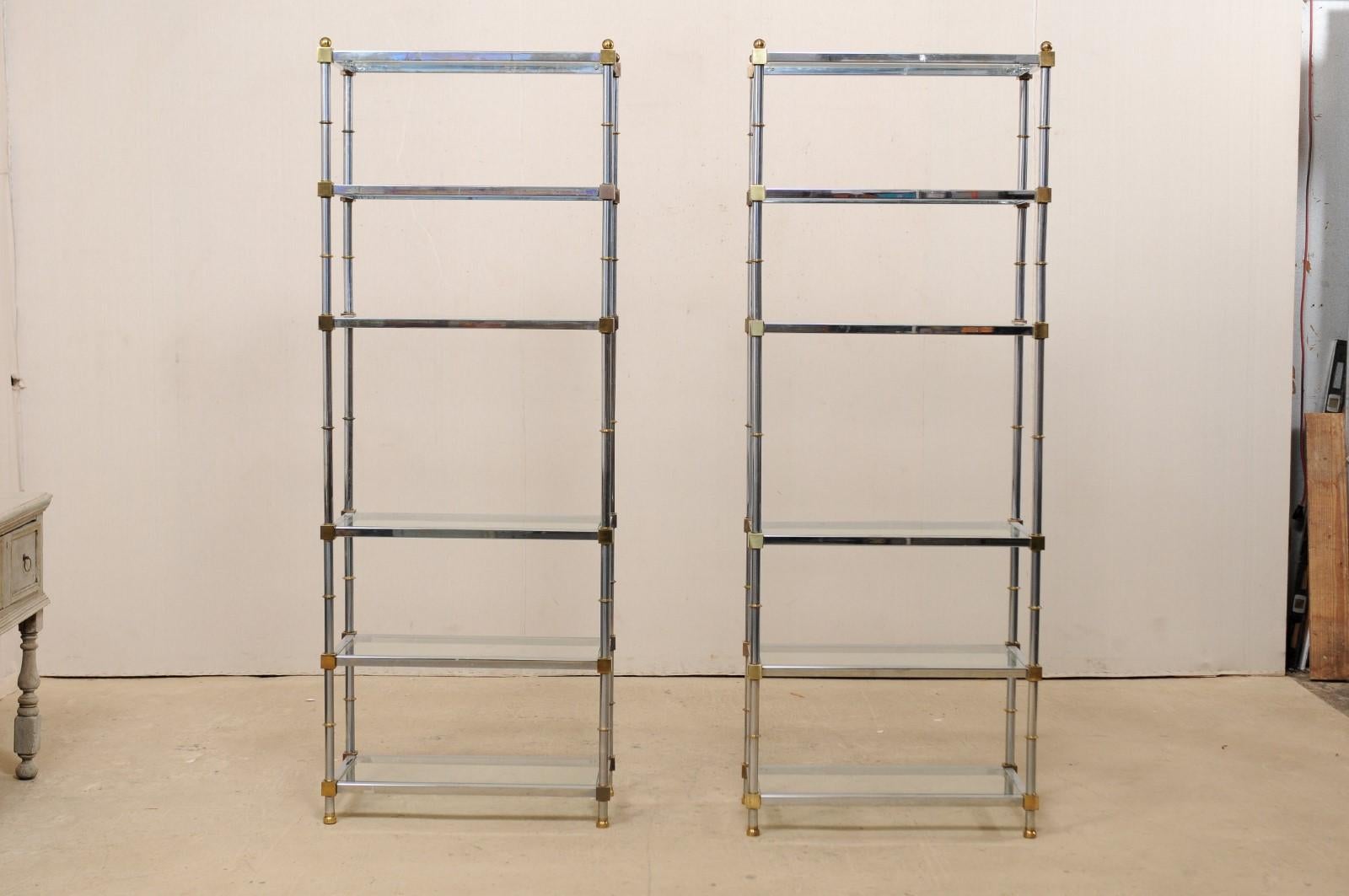 A pair of Hollywood Regency style open display chrome and glass shelves from the mid-20th century. This tall pair of midcentury American shelves have a wonderfully sleek design, reminiscent of Maison Jansen style. These modern designed bookshelves