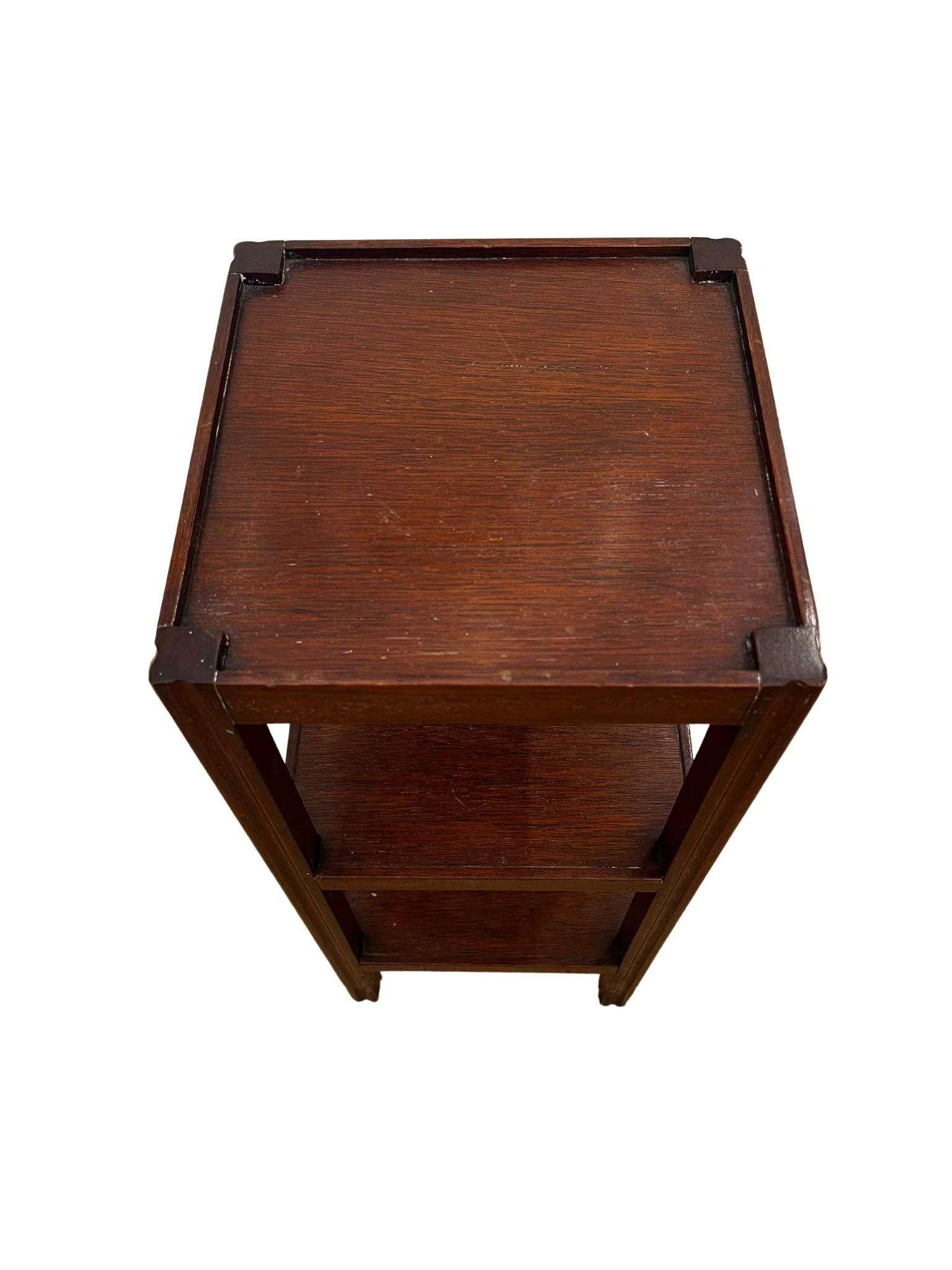 Elegant mid-century walnut drinks table featuring three tray-edge tiers on slender legs. Its airy, silhouette keeps cocktails, books, or plants neatly staged while adding a warm modern accent to any room. Priced as a pair.