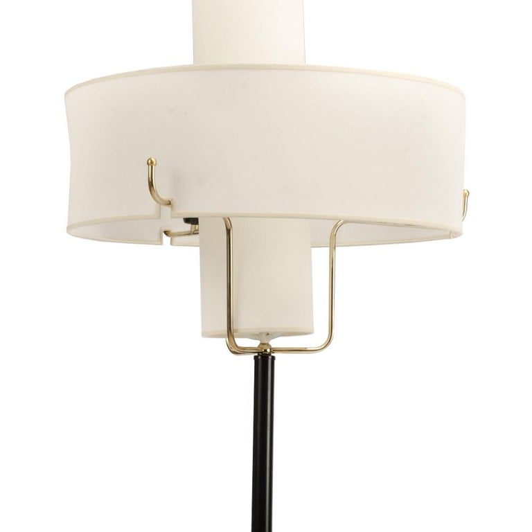 A pair of midcentury modern brass and gilt iron floor lamps with drum