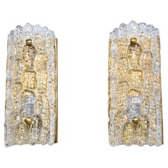 A pair of mid-century glass and brass wall lights by Carl Fagerlund